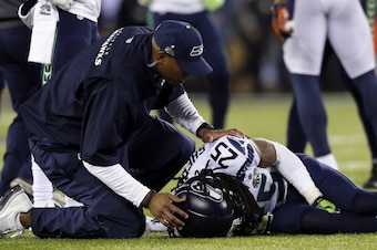 EAST RUTHERFORD, NJ - FEBRUARY 02:  Cornerback Richard Sherman #25 of the Seattle Seahawks recieves medical attention after an injury during Super Bowl XLVIII against the Denver Broncos at MetLife Stadium on February 2, 2014 in East Rutherford, New Jersey