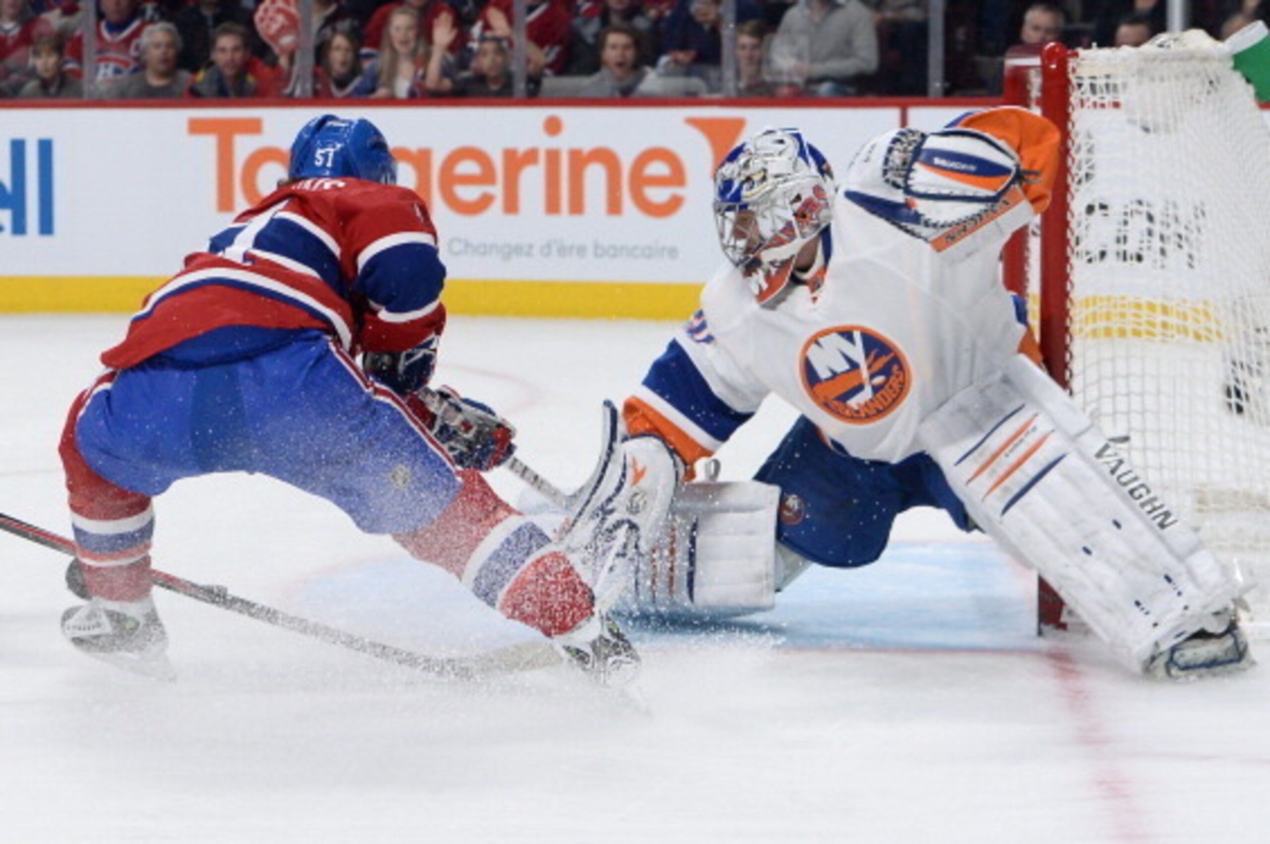 MONTREAL, QC - APRIL 10: Evgeni Nabokov #20 of the New York Islanders blocks the shot by David Desharnais #51 of the Montreal Canadiens during the NHL game on April 10, 2014 at the Bell Centre in Montreal, Quebec, Canada. (Photo by Francois Lacasse/NHLI v