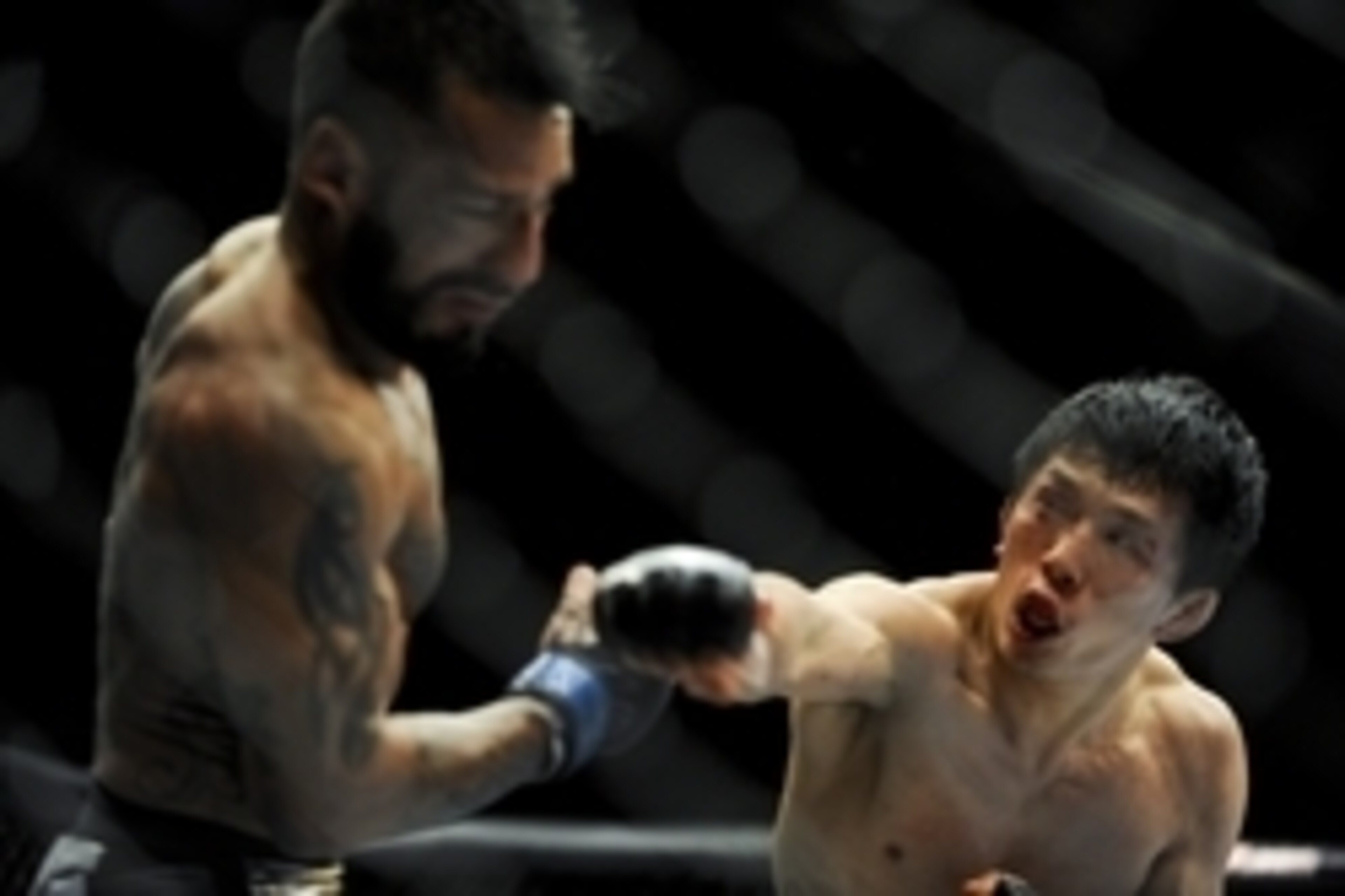May 24, 2014; Las Vegas, NV, USA; Takeya Mizugaki (red) throws a punch at Francisco Rivera (blue) during their UFC 173 bantamweight bout at MGM Grand Garden Arena. Mizugaki won the bout by unanimous decision. Mandatory Credit: Stephen R. Sylvanie-USA TODA May 24, 2014; Las Vegas, NV, USA; Takeya Mizugaki (red) throws a punch at Francisco Rivera (blue) during their UFC 173 bantamweight bout at MGM Grand Garden Arena. Mizugaki won the bout by unanimous decision. Mandatory Credit: Stephen R. Sylvanie-USA TODA