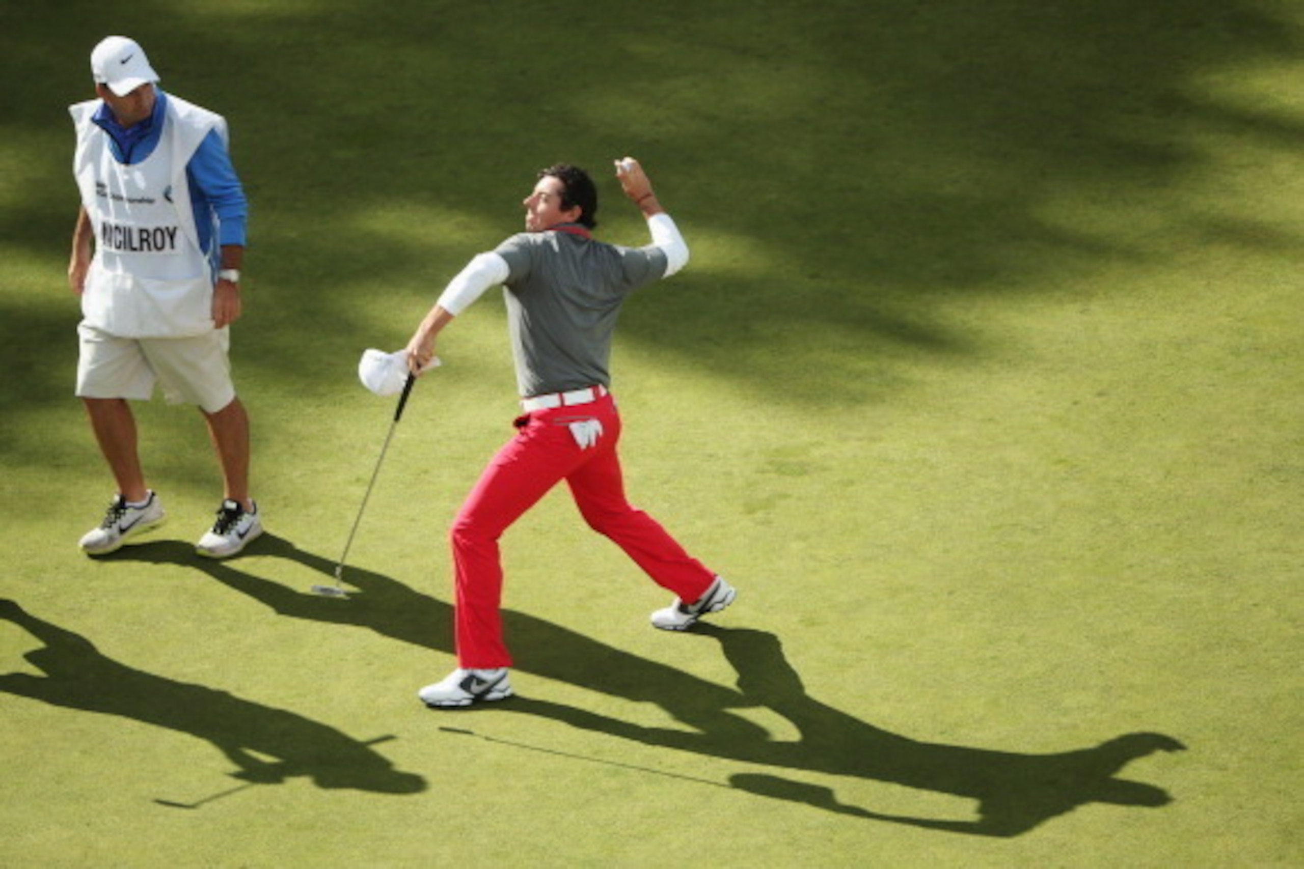 VIRGINIA WATER, ENGLAND - MAY 25:  Rory McIlroy of Northern Ireland throws his ball to the crowd after holing a birdie putt on the 18th green during day four of the BMW PGA Championship at Wentworth on May 25, 2014 in Virginia Water, England.  (Photo by A
