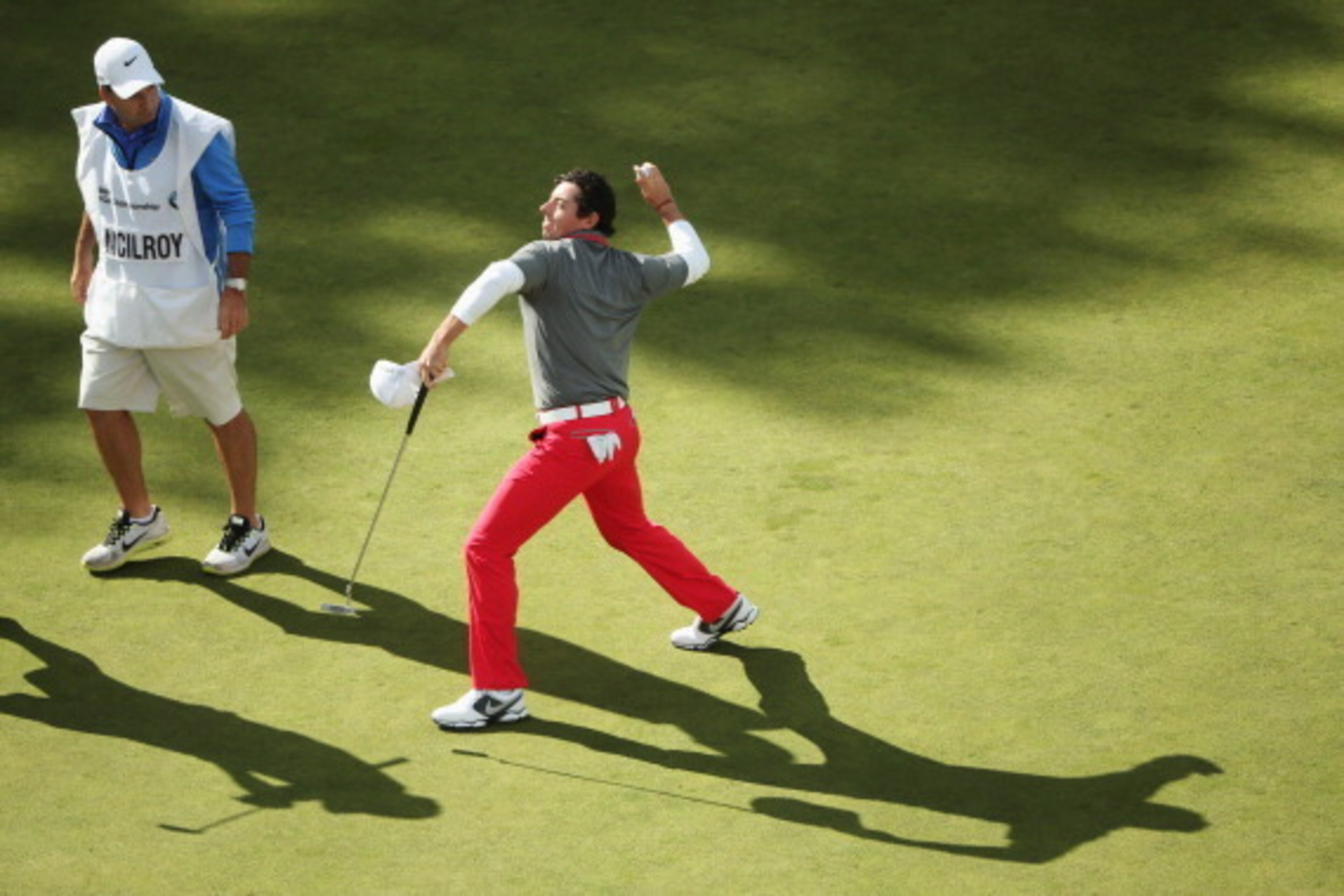 VIRGINIA WATER, ENGLAND - MAY 25:  Rory McIlroy of Northern Ireland throws his ball to the crowd after holing a birdie putt on the 18th green during day four of the BMW PGA Championship at Wentworth on May 25, 2014 in Virginia Water, England.  (Photo by A