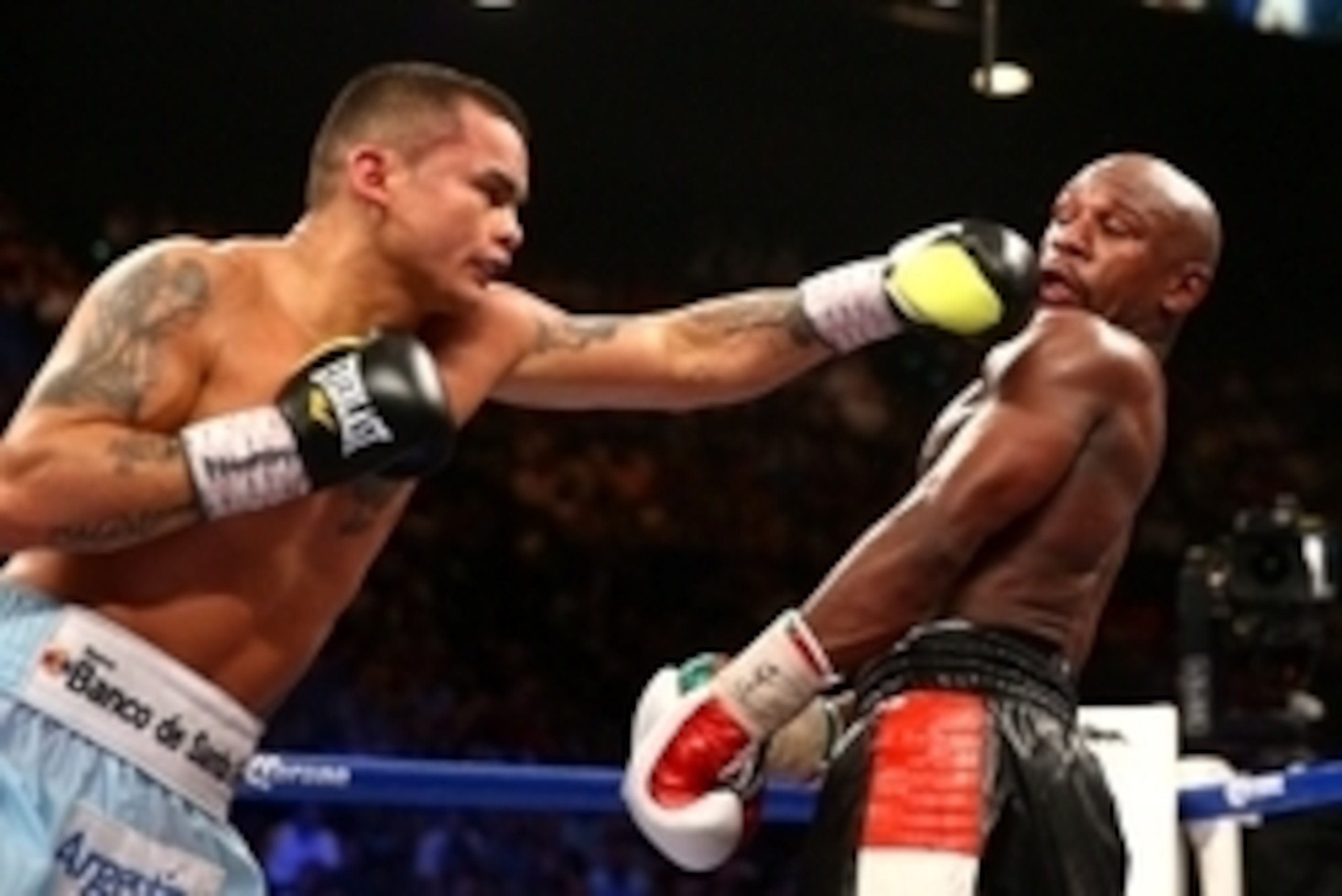 May 3, 2014; Las Vegas, NV, USA; Marcos Maidana (left) hits Floyd Mayweather Jr during their fight at MGM Grand. Mandatory Credit: Mark J. Rebilas-USA TODAY Sports