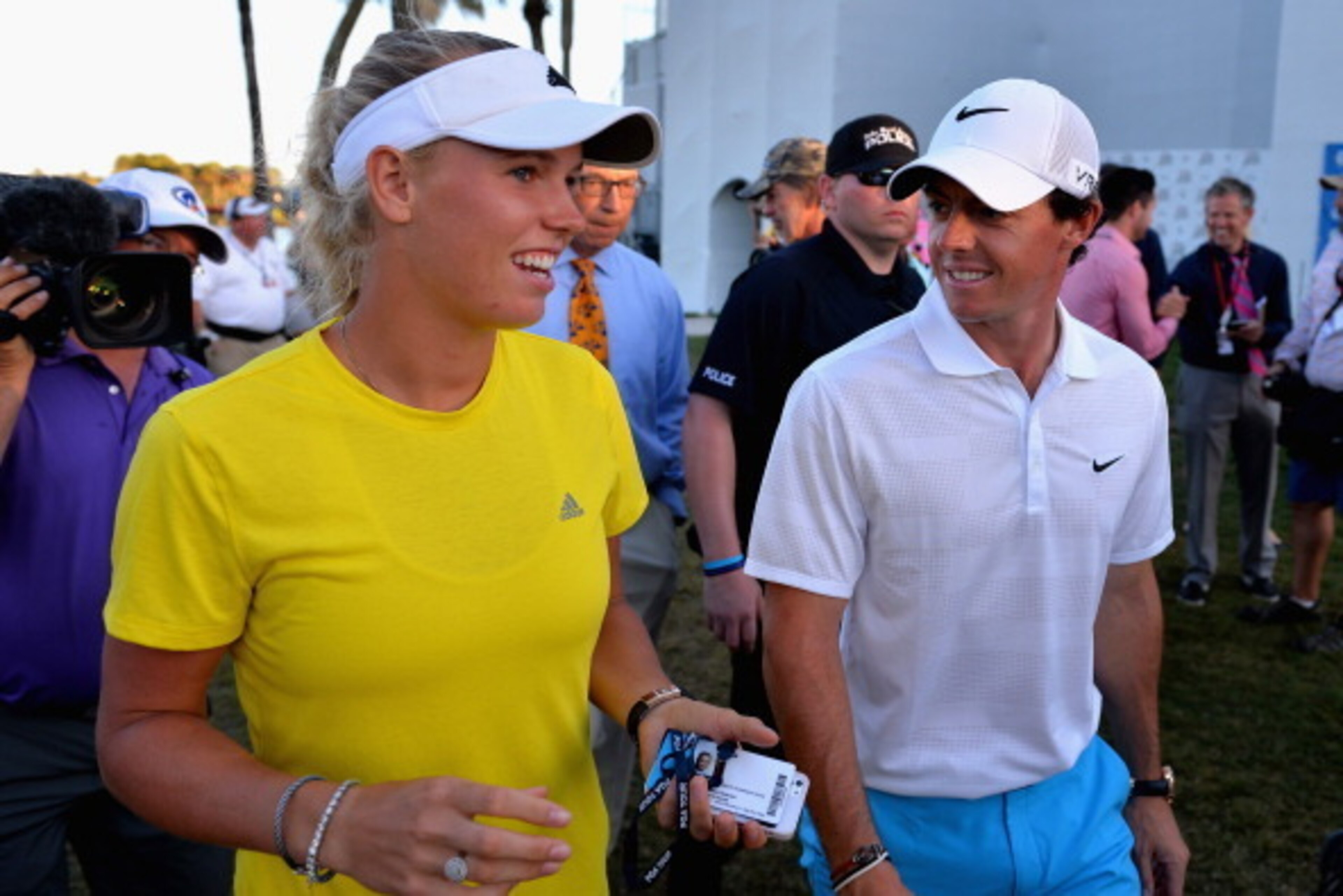 PALM BEACH GARDENS, FL - MARCH 01:  Caroline Wozniacki of Denmark (L) walks with her fiancee Rory McIlroy of Northern Ireland following the third round of The Honda Classic at PGA National Resort and Spa on March 1, 2014 in Palm Beach Gardens, Florida.  (