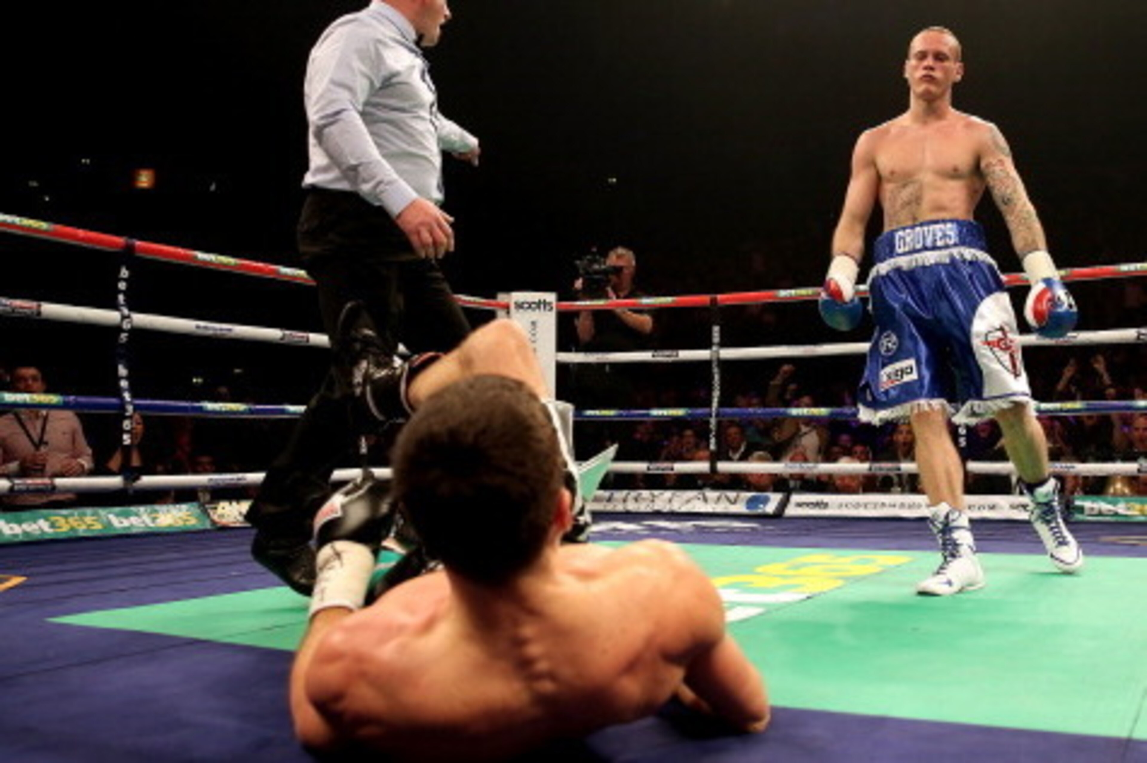 MANCHESTER, ENGLAND - NOVEMBER 23:  Carl Froch is knocked down in the first by George Groves during their IBF and WBA World Super Middleweight bout at Phones4u Arena on November 23, 2013 in Manchester, England.  (Photo by Scott Heavey/Getty Images)