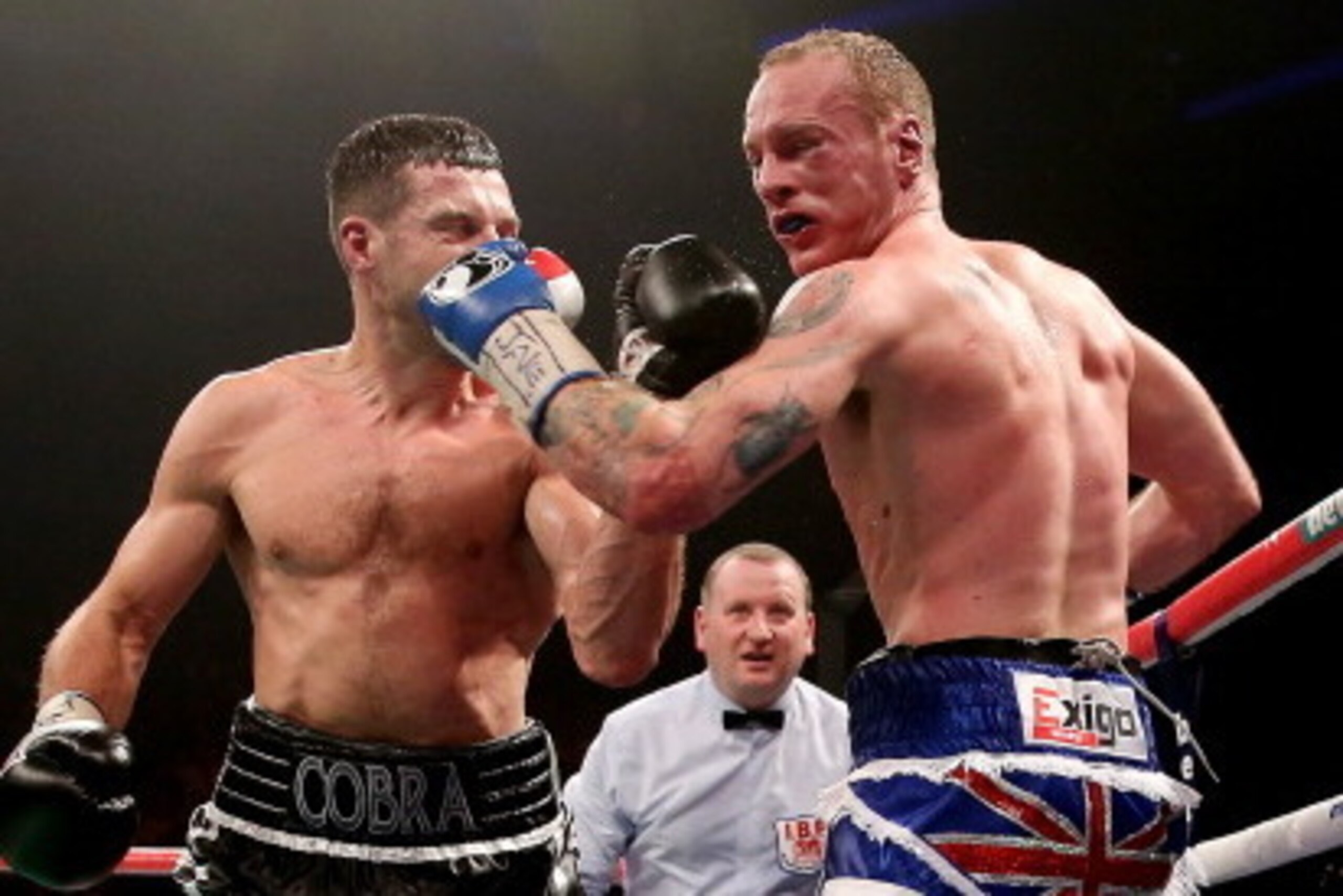 MANCHESTER, ENGLAND - NOVEMBER 23:  Carl Froch (L) in action with George Groves during their IBF and WBA World Super Middleweight bout at Phones4u Arena on November 23, 2013 in Manchester, England.  (Photo by Scott Heavey/Getty Images)