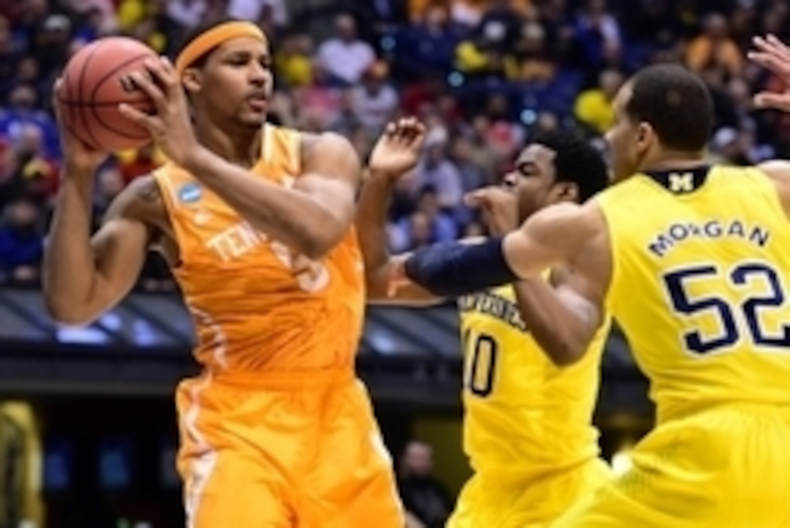Mar 28, 2014; Indianapolis, IN, USA; Tennessee Volunteers forward Jarnell Stokes (5) looks to pass the ball away from Michigan Wolverines forward Jordan Morgan (52) and guard Derrick Walton Jr. (10)  in the first half in the semifinals of the midwest regi
