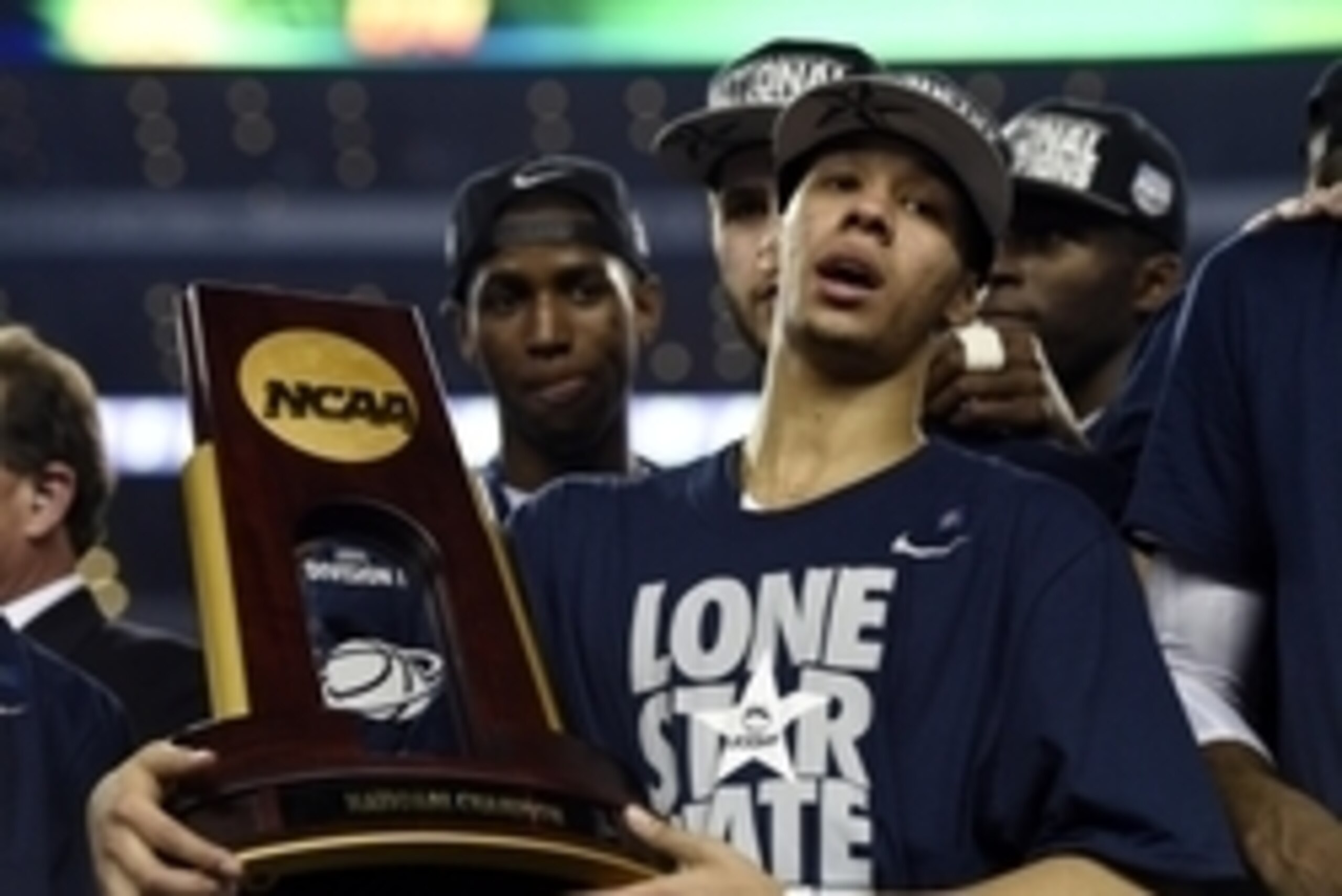 Apr 7, 2014; Arlington, TX, USA; Connecticut Huskies guard Shabazz Napier (13) holds the national championship trophy after defeating the Kentucky Wildcats in the championship game of the Final Four in the 2014 NCAA Mens Division I Championship tournament