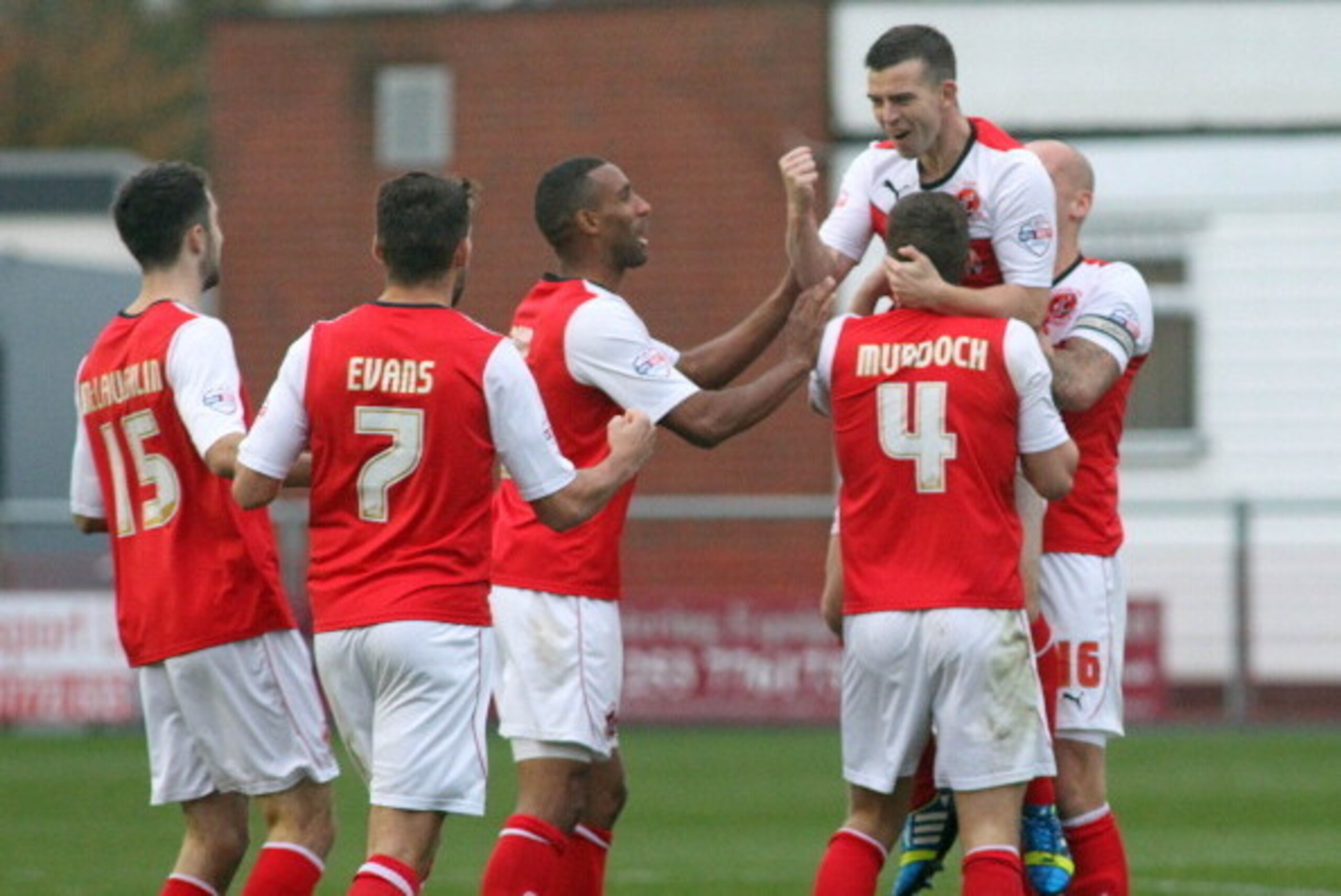 FLEETWOOD, UNITED KINGDOM - NOVEMBER 02: Steven Schumacher of Fleetwood Town (lifted) celebrates with team-mates after scoring the second goal during the Sky Bet League two match between Fleetwood Town and Newport County at Highbury Stadium on November 02