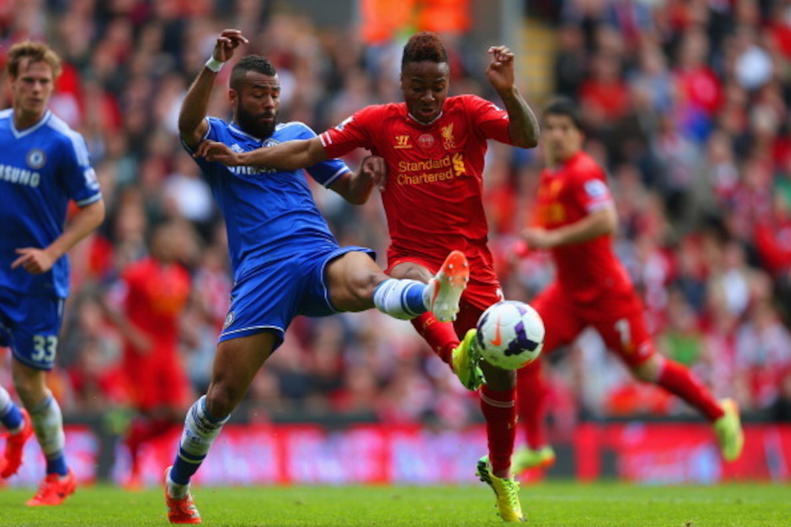 LIVERPOOL, ENGLAND - APRIL 27:  Ashley Cole of Chelsea and Raheem Sterling of Liverpool battle for the ball during the Barclays Premier League match between Liverpool and Chelsea at Anfield on April 27, 2014 in Liverpool, England.  (Photo by Clive Brunski