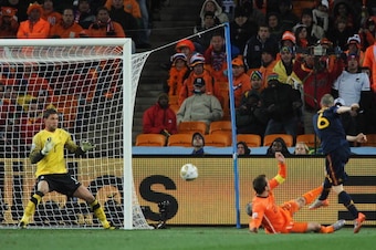 JOHANNESBURG, SOUTH AFRICA - JULY 11:  Andres Iniesta of Spain scores the opening goal late into extra time past Maarten Stekelenburg of the Netherlands as Rafael Van der Vaart tries to defend during the 2010 FIFA World Cup South Africa Final match betwee