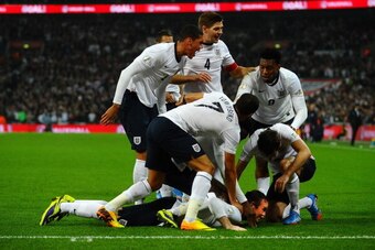 LONDON, ENGLAND - OCTOBER 15:  Wayne Rooney of England celebrates after scoring his team's opening goal during the FIFA 2014 World Cup Qualifying Group H match between England and Poland at Wembley Stadium on October 15, 2013 in London, England.  (Photo b