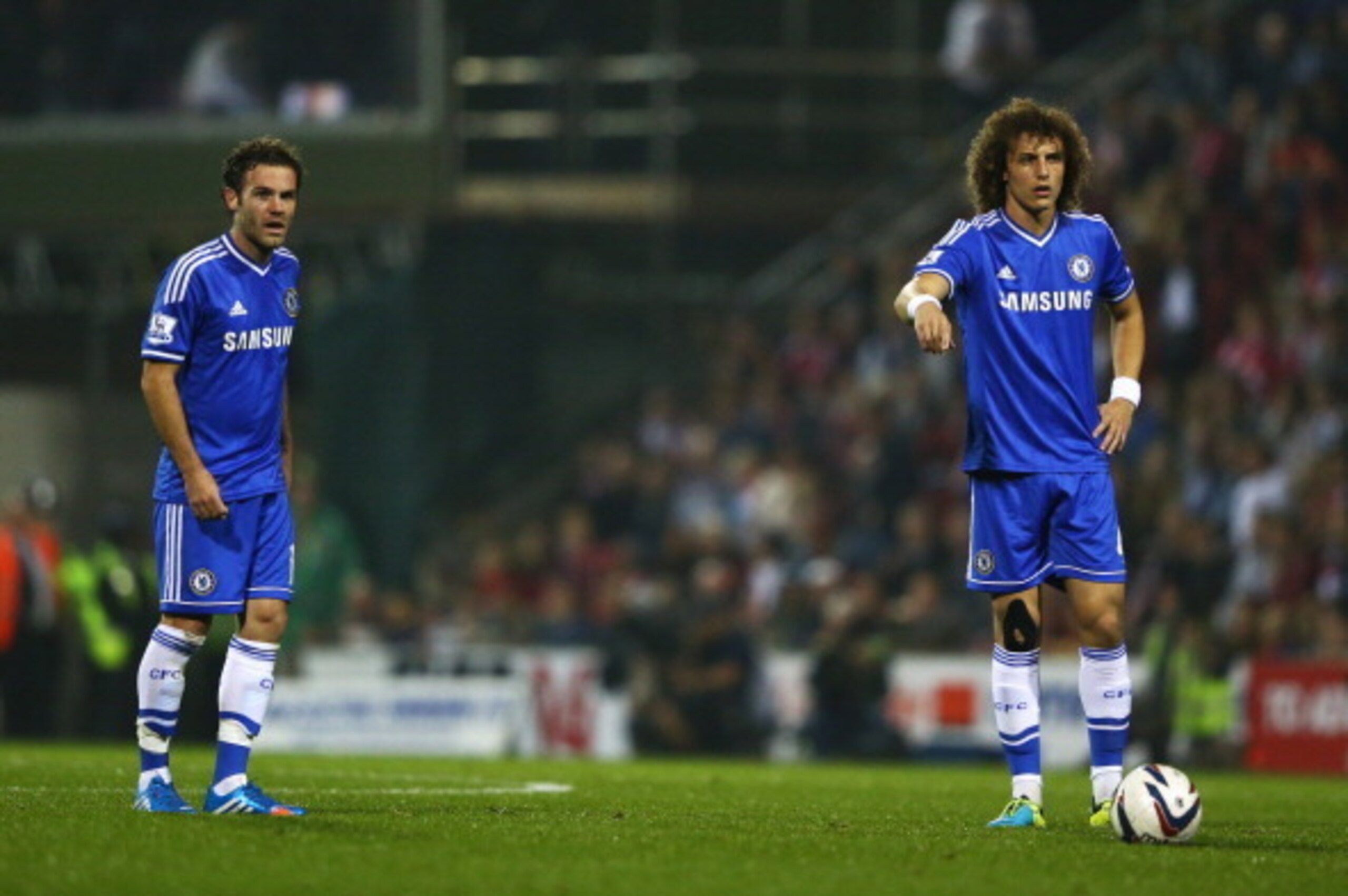 SWINDON, ENGLAND - SEPTEMBER 24:  Juan Mata (L) and David Luiz of Chelsea organise a free kick during the Capital One Cup Third Round match between Swindon Town and Chelsea at County Ground on September 24, 2013 in Swindon, England.  (Photo by Michael Ste