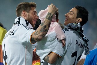 MADRID, SPAIN - MAY 25:  Sergio Ramos (L) of Real Madrid CF is shown with teammate Angel Di Maria and his daughter during the Real Madrid celebration the day after winning the UEFA Champions League Final at Santiago Bernabeu stadium on May 25, 2014 in Mad