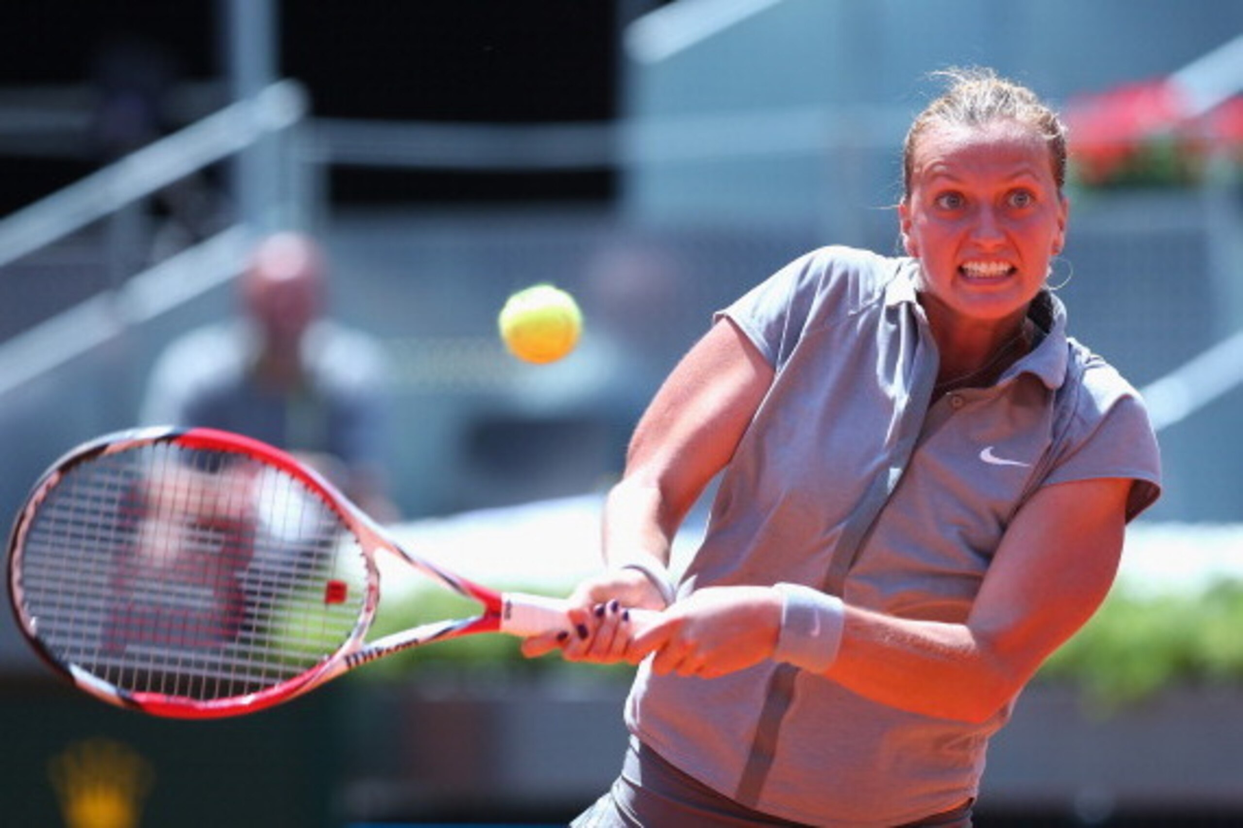 MADRID, SPAIN - MAY 10:  Petra Kvitova of Czech Republic in action in her match against Simona Halep of Romania during day eight of the Mutua Madrid Open tennis tournament at the Caja Magica on May 10, 2014 in Madrid, Spain.  (Photo by Julian Finney/Getty
