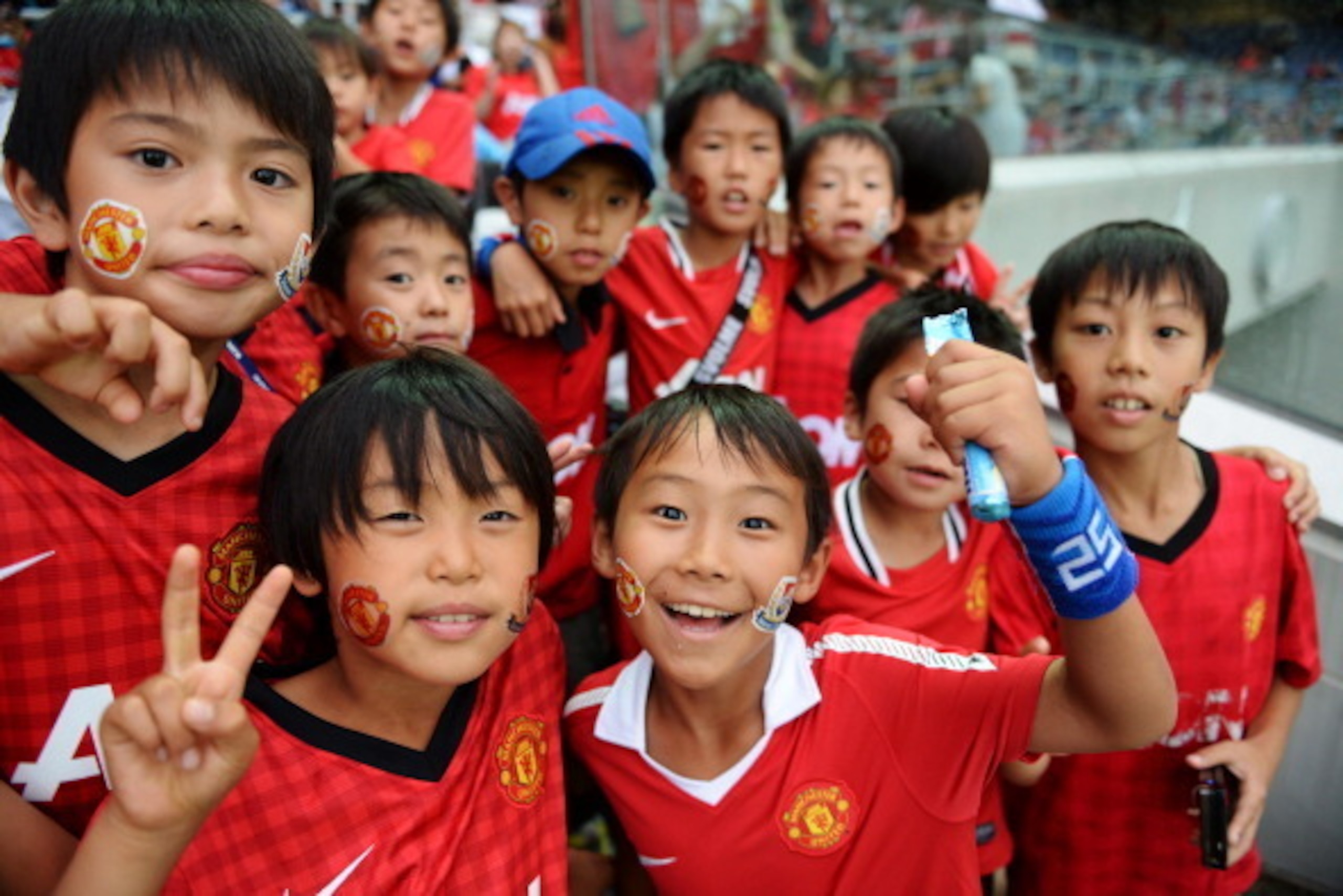 YOKOHAMA, JAPAN - JULY 23:  Manchester United fans pose prior to the pre-season friendly match between Yokohama F.Marinos and Manchester United at Nissan Stadium on July 23, 2013 in Yokohama, Kanagawa, Japan.  (Photo by Atsushi Tomura/Getty Images)