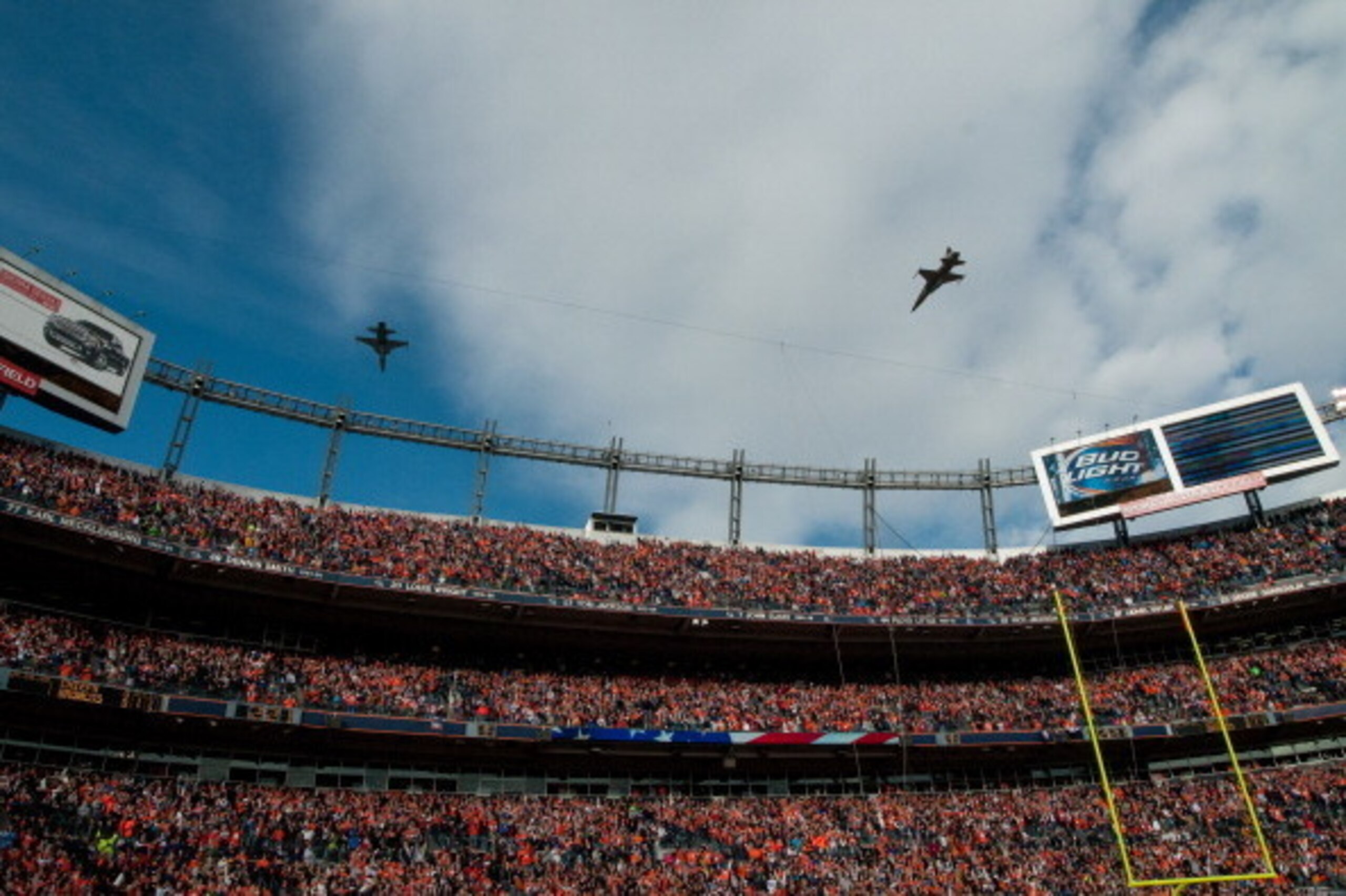 DENVER, CO - DECEMBER 30: A pair of Air Force F-18 Hornets perform a flyover and fans wearing orange fill the stands before a game between the Denver Broncos and the Kansas City Chiefs at Sports Authority Field at Mile High on December 30, 2012 in Denver,
