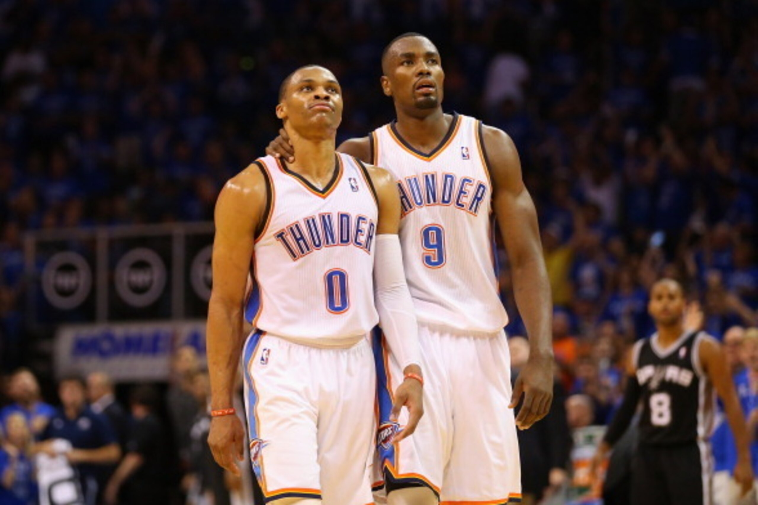OKLAHOMA CITY, OK - MAY 25:  Russell Westbrook #0 of the Oklahoma City Thunder reacts with Serge Ibaka #9 after making a three pointer to end the first half against the San Antonio Spurs during Game Three of the Western Conference Finals of the 2014 NBA P