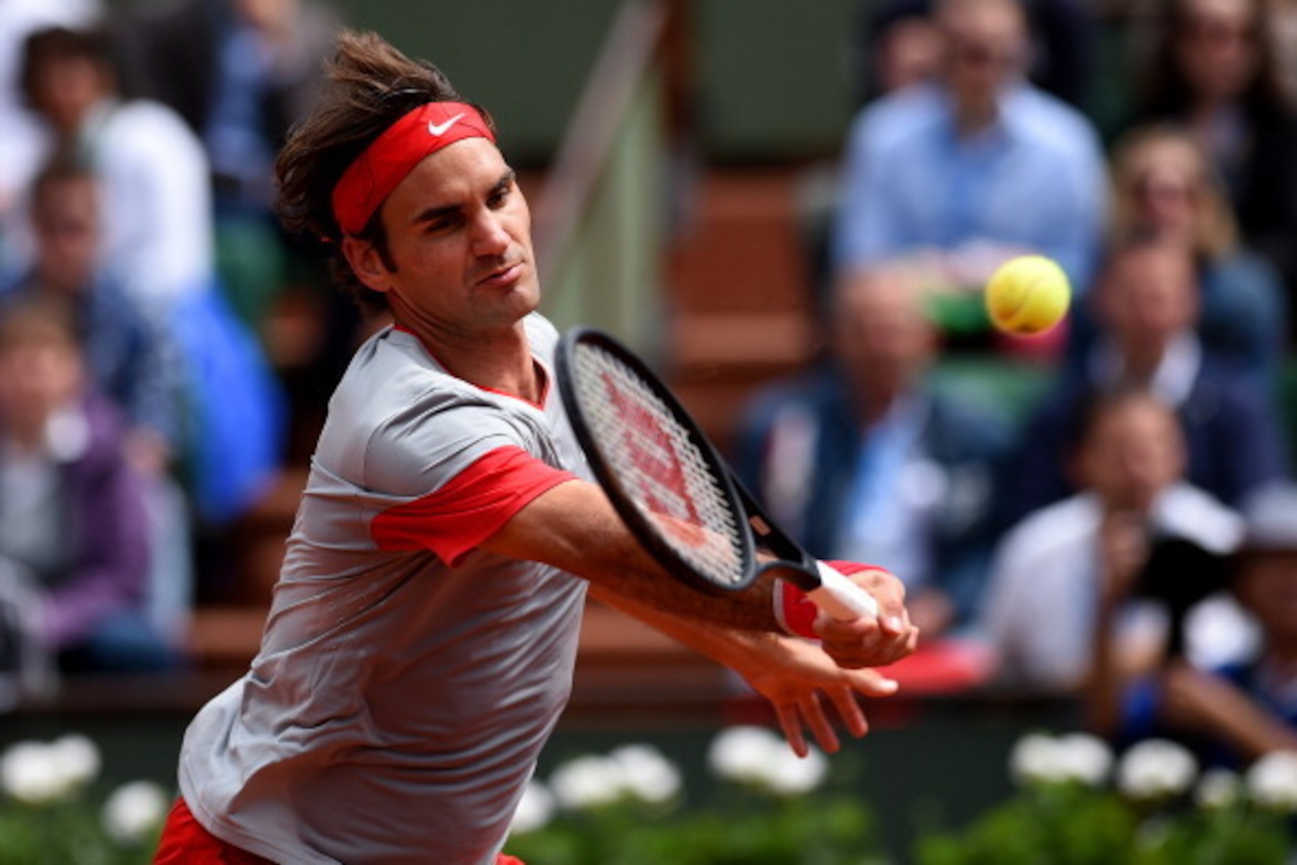 PARIS, FRANCE - MAY 25:  Roger Federer of Switzerland returns a shot during his men's singles match against Lukas Lacko of Slovakia on day one of the French Open at Roland Garros on May 25, 2014 in Paris, France.  (Photo by Matthias Hangst/Getty Images)