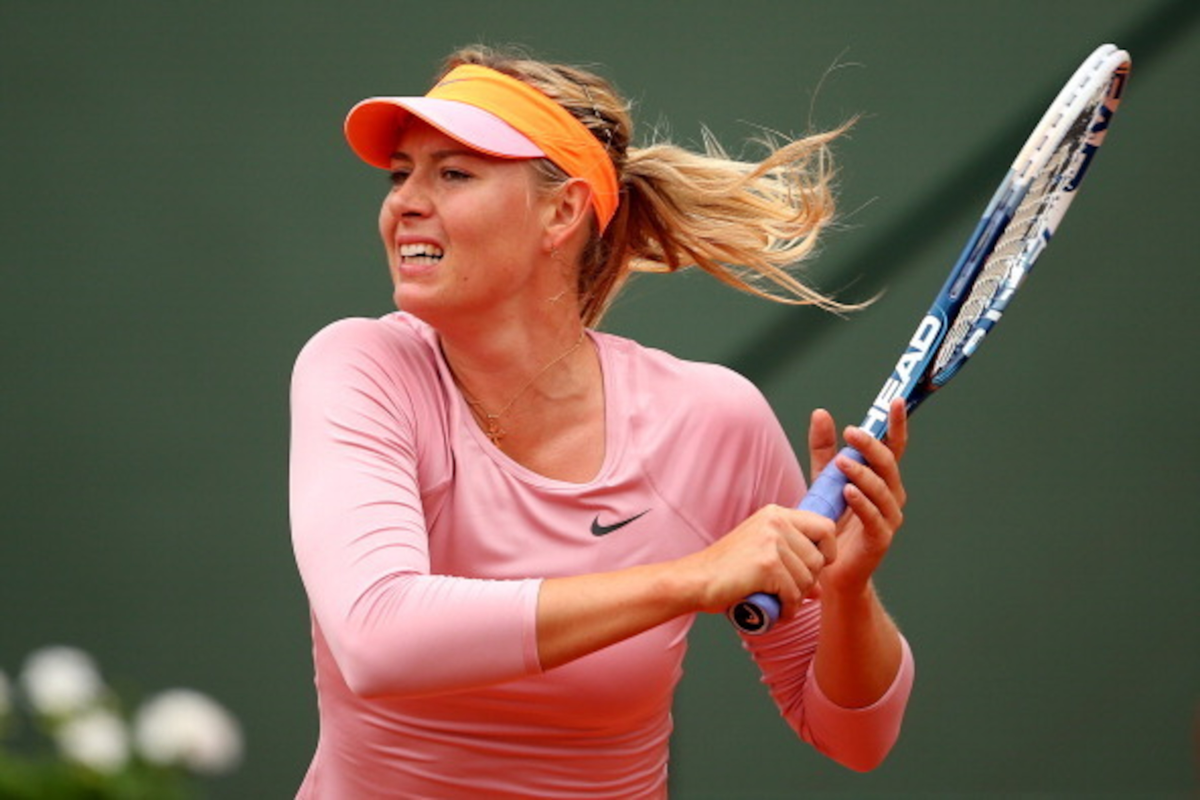 PARIS, FRANCE - MAY 26: Maria Sharapova of Russia returns a shot during her women's singles match against Ksenia Pervak of Russia on day two of the French Open at Roland Garros on May 26, 2014 in Paris, France. (Photo by Clive Brunskill/Getty Images) PARIS, FRANCE - MAY 26: Maria Sharapova of Russia returns a shot during her women's singles match against Ksenia Pervak of Russia on day two of the French Open at Roland Garros on May 26, 2014 in Paris, France. (Photo by Clive Brunskill/Getty Images)