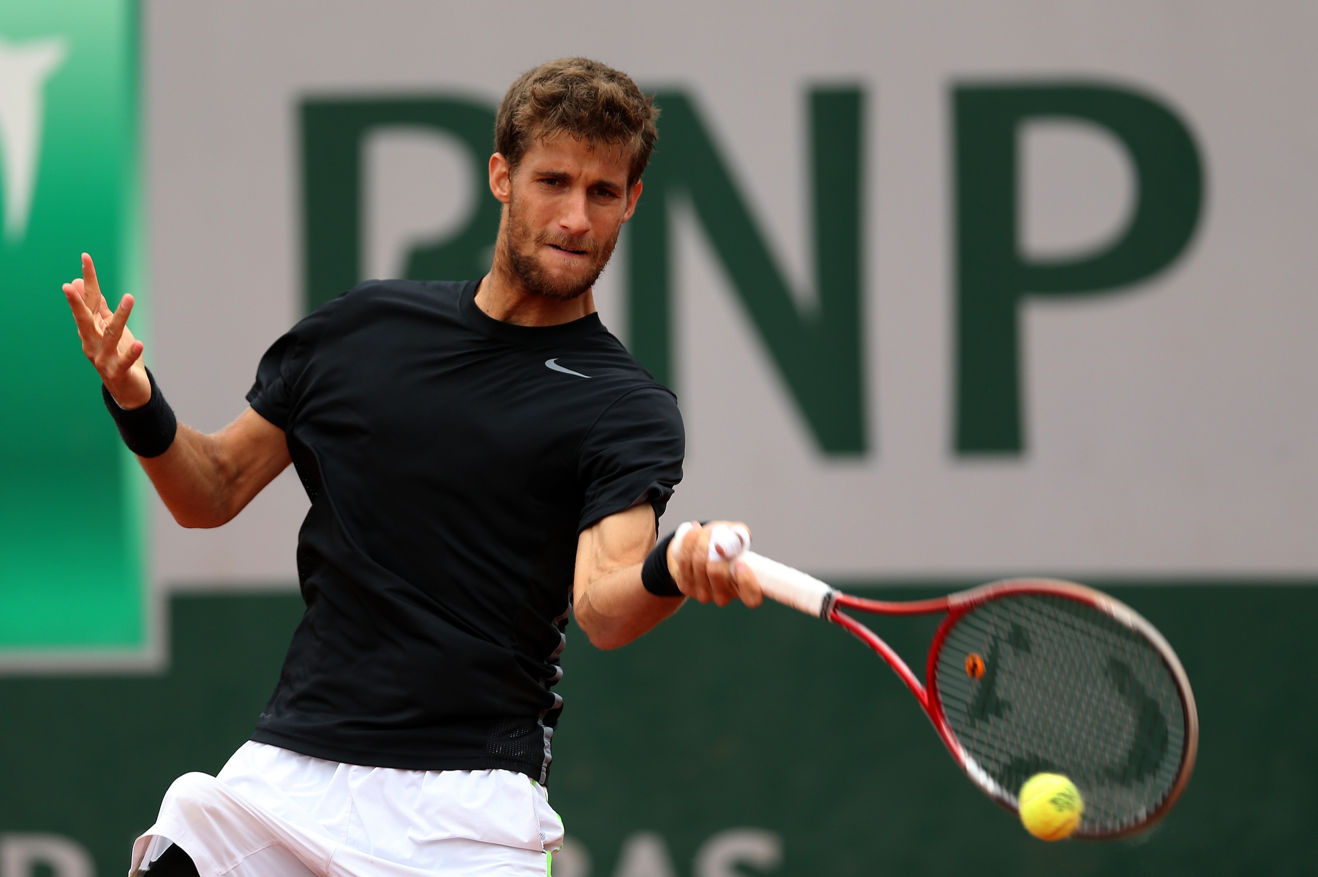 PARIS, FRANCE - MAY 26:  Martin Klizan of Slovakia returns a shot during his men's singles match against Kei Nishikori of Japan on day two of the French Open at Roland Garros on May 26, 2014 in Paris, France.  (Photo by Matthew Stockman/Getty Images)