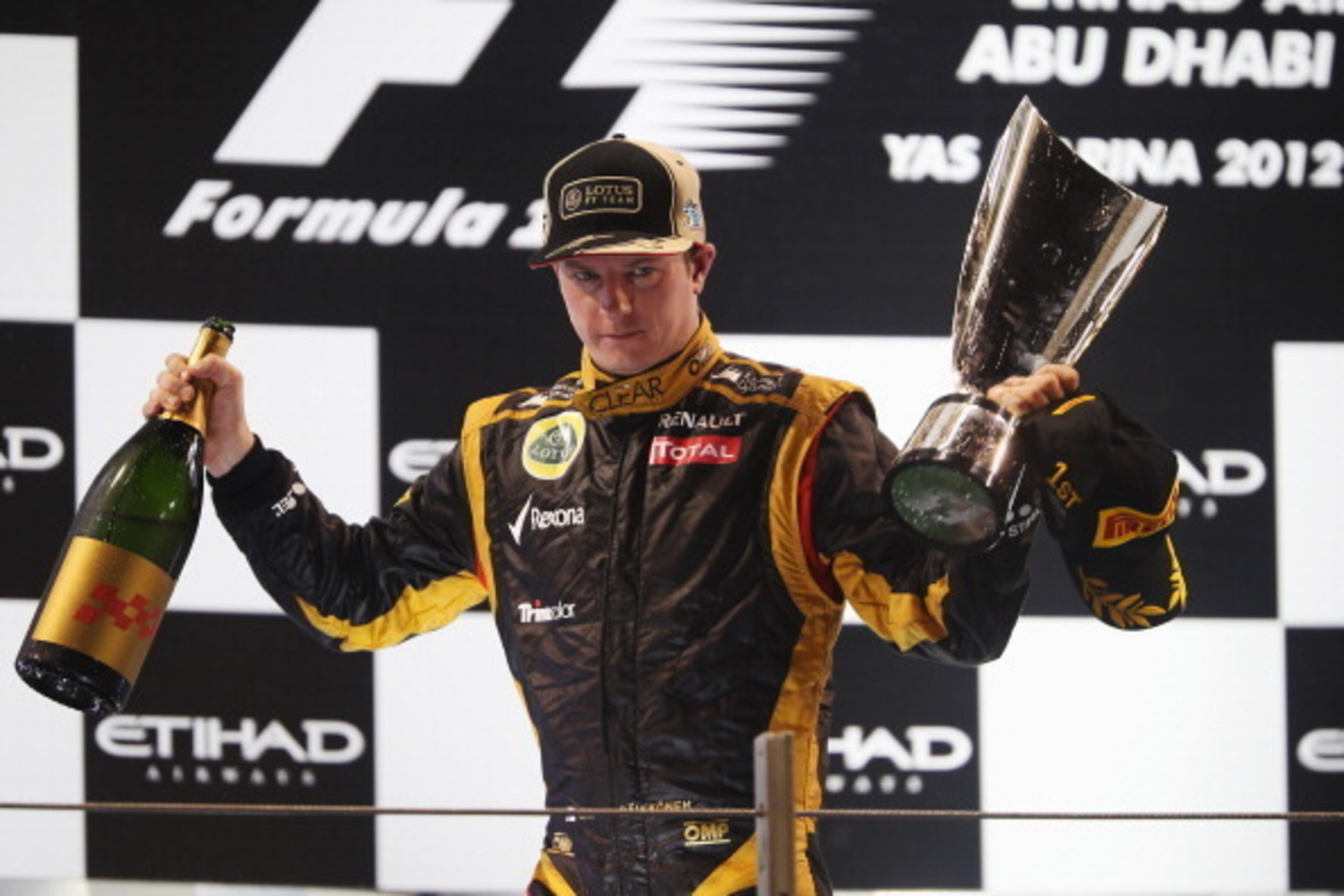 ABU DHABI, UNITED ARAB EMIRATES - NOVEMBER 04:  Kimi Raikkonen of Finland and Lotus celebrates on the podium after winning the Abu Dhabi Formula One Grand Prix at the Yas Marina Circuit on November 4, 2012 in Abu Dhabi, United Arab Emirates.  (Photo by Ma