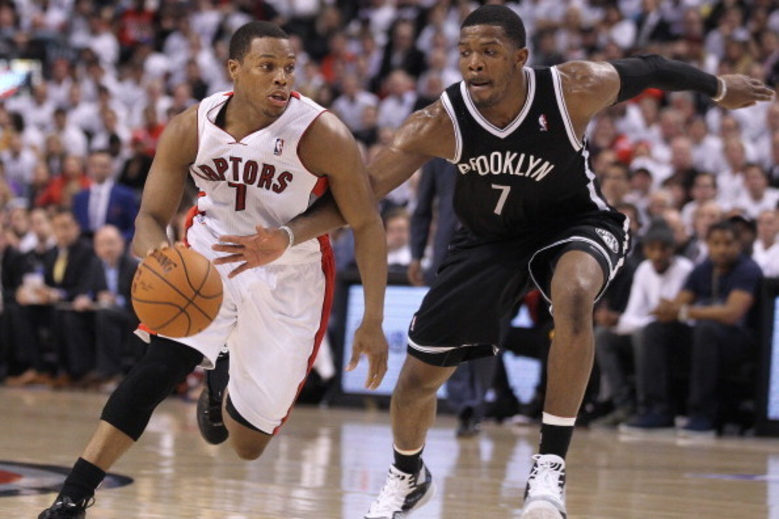 TORONTO, ON - APRIL 30:  Joe Johnson #7 of the Brooklyn Nets defends against Kyle Lowry #7 of the Toronto Raptors in Game Five of the NBA Eastern Conference Quarterfinals at the Air Canada Centre on April 30, 2014 in Toronto, Ontario, Canada. The Raptors 