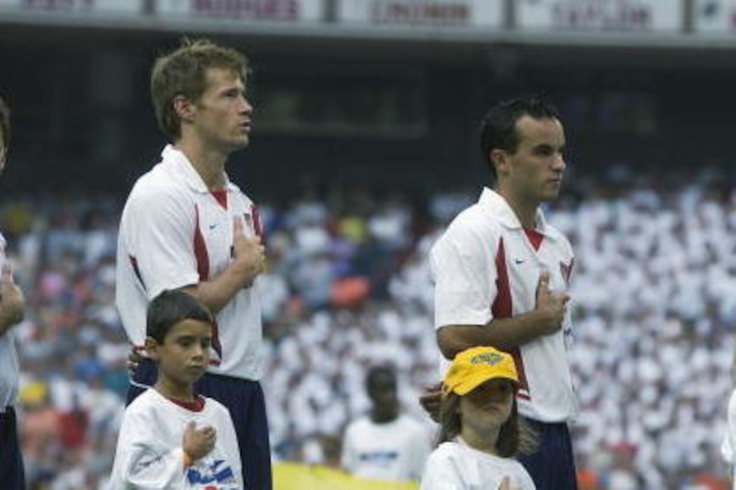 WASHINGTON - AUGUST 3:  Forward Brian McBride #20, forward Landon Donovan #21 and defender Alexi Lalas #22 of the US National Team stand for the National Anthem before the MLS All Star match against the MLS All Star Team on August 3, 2002 at RFK Stadium i