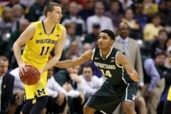 Mar 16, 2014; Indianapolis, IN, USA; Michigan Wolverines guard Nik Stauskas (11) is guarded by Michigan State Spartans guard Gary Harris (14) in the championship game for the Big Ten college basketball tournament at Bankers Life Fieldhouse. Mandatory Cred