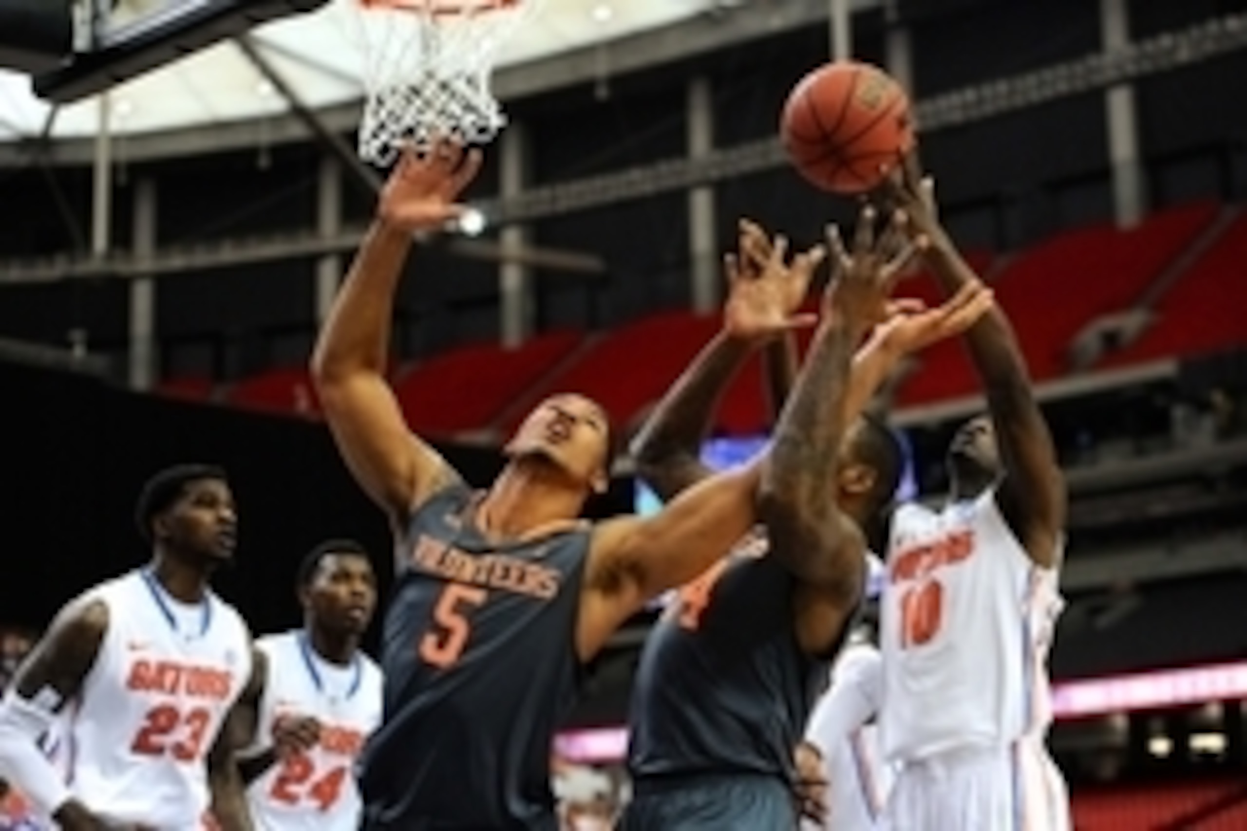 Mar 15, 2014; Atlanta, GA, USA; Tennessee Volunteers forward Jarnell Stokes (5) and forward Jeronne Maymon (34) battle for a rebound with Florida Gators forward Dorian Finney-Smith (10) during the first half in the semifinals of the SEC college basketball