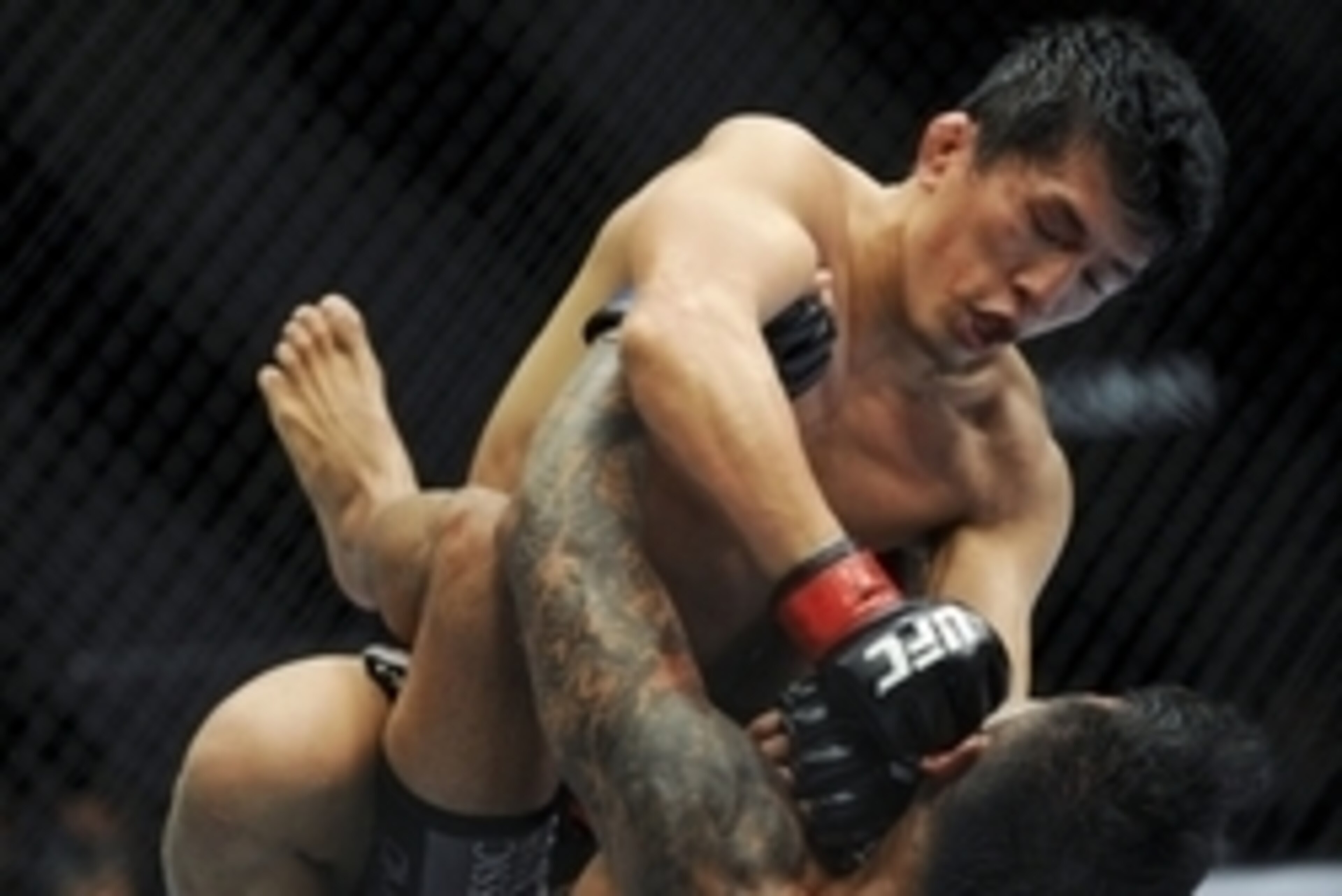 May 24, 2014; Las Vegas, NV, USA; Takeya Mizugaki (red) punches Francisco Rivera (blue) during their UFC 173 bantamweight bout at MGM Grand Garden Arena. Mizugaki won the bout by unanimous decision. Mandatory Credit: Stephen R. Sylvanie-USA TODAY Sports