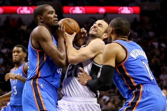 SAN ANTONIO, TX - MAY 21:  Manu Ginobili #20 of the San Antonio Spurs drives on Kevin Durant #35 and Russell Westbrook #0 of the Oklahoma City Thunder in the first half in Game Two of the Western Conference Finals during the 2014 NBA Playoffs at AT&T Cent