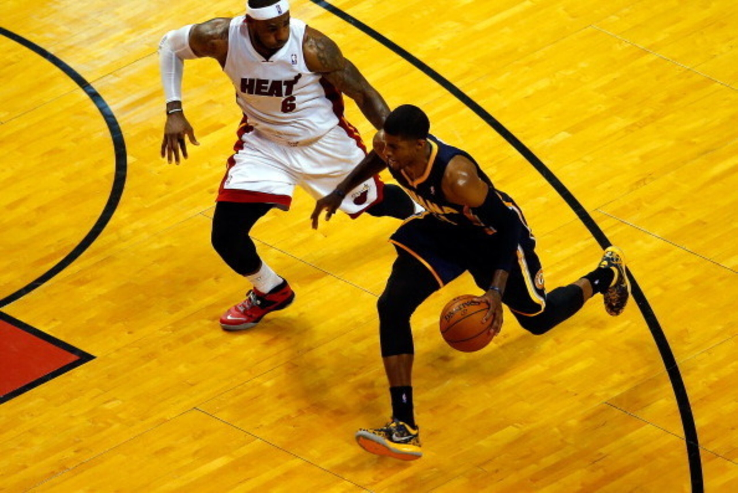 MIAMI, FL - MAY 26:  Paul George #24 of the Indiana Pacers drives to the basket as LeBron James #6 of the Miami Heat defends during Game Four of the Eastern Conference Finals of the 2014 NBA Playoffs at American Airlines Arena on May 26, 2014 in Miami, Fl