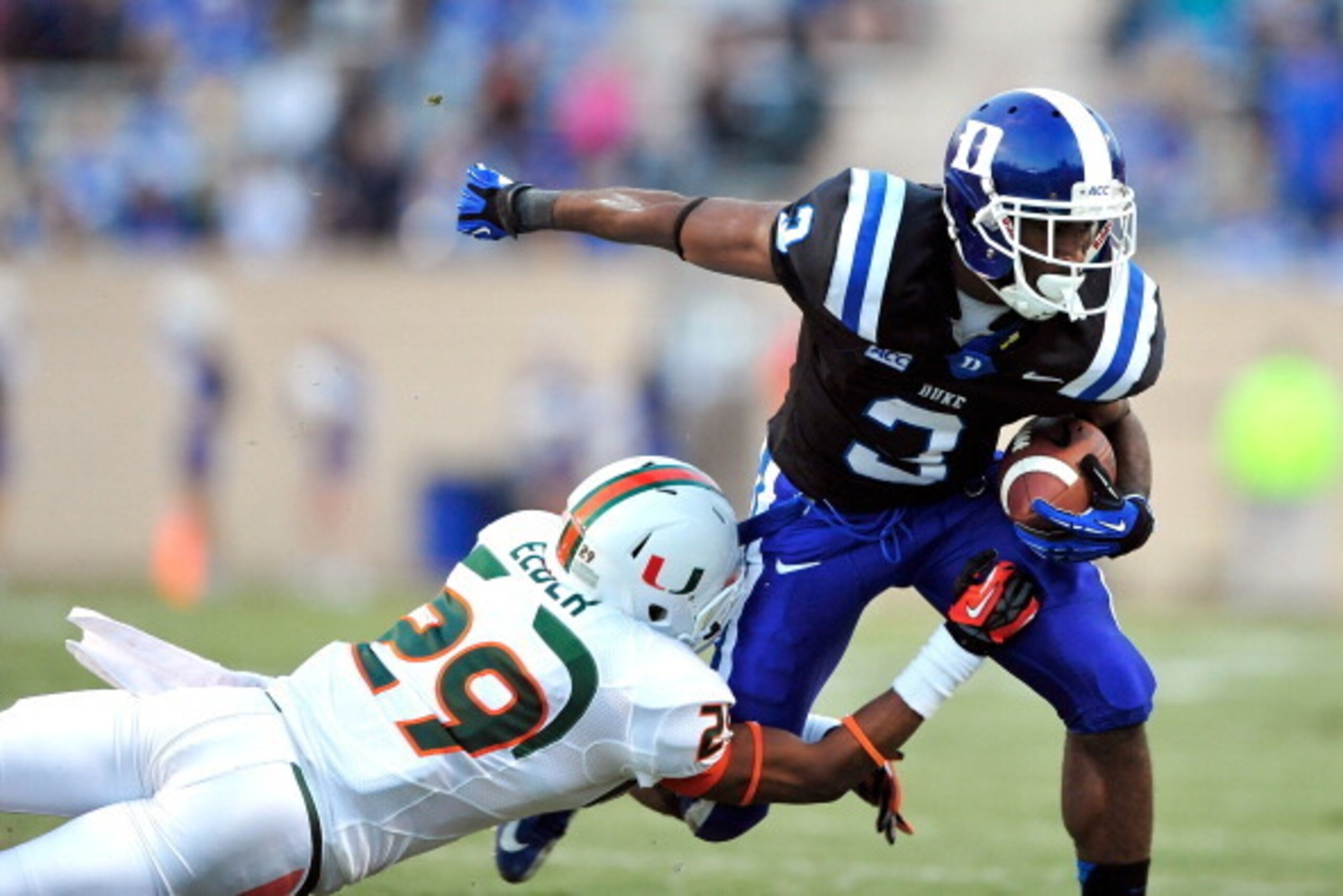 DURHAM, NC - NOVEMBER 16:  Corn Elder #29 of the Miami Hurricanes makes a diving tackle to stop Jamison Crowder #3 of the Duke Blue Devils during play at Wallace Wade Stadium on November 16, 2013 in Durham, North Carolina.  (Photo by Grant Halverson/Getty