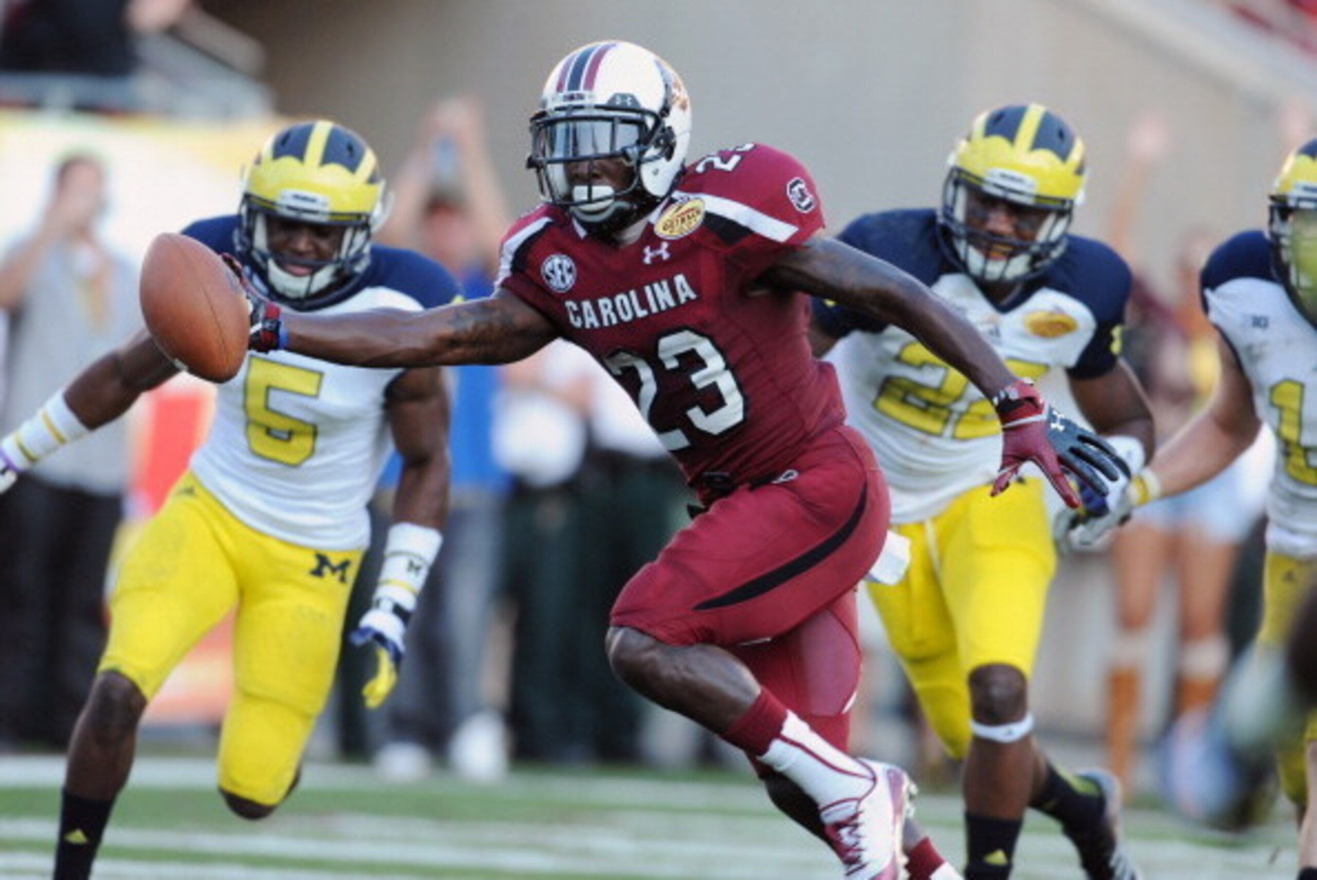TAMPA, FL - JANUARY 1: Wide receiver Bruce Ellington #23 of the South Carolina Gamecocks grabs a 32-yard, game-winning touchdown pass in the fourth quarter against the Michigan Wolverines in the Outback Bowl January 1, 2013 at Raymond James Stadium in Ta TAMPA, FL - JANUARY 1: Wide receiver Bruce Ellington #23 of the South Carolina Gamecocks grabs a 32-yard, game-winning touchdown pass in the fourth quarter against the Michigan Wolverines in the Outback Bowl January 1, 2013 at Raymond James Stadium in Ta