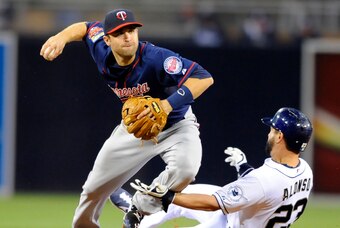 May 21, 2014; San Diego, CA, USA; Minnesota Twins second baseman Brian Dozier (2) has a double play broken up by San Diego Padres first baseman Yonder Alonso (23) during the sixth inning at Petco Park. Mandatory Credit: Christopher Hanewinckel-USA TODAY S