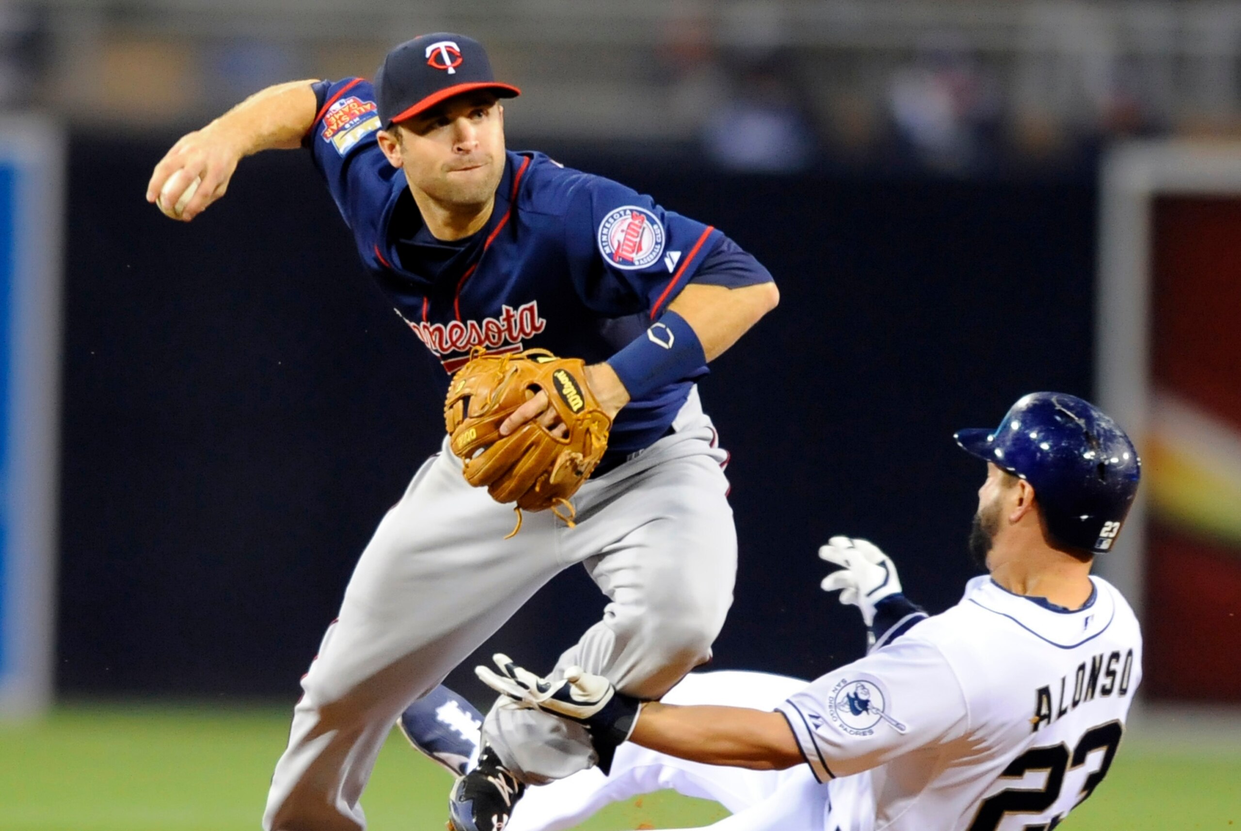 May 21, 2014; San Diego, CA, USA; Minnesota Twins second baseman Brian Dozier (2) has a double play broken up by San Diego Padres first baseman Yonder Alonso (23) during the sixth inning at Petco Park. Mandatory Credit: Christopher Hanewinckel-USA TODAY S