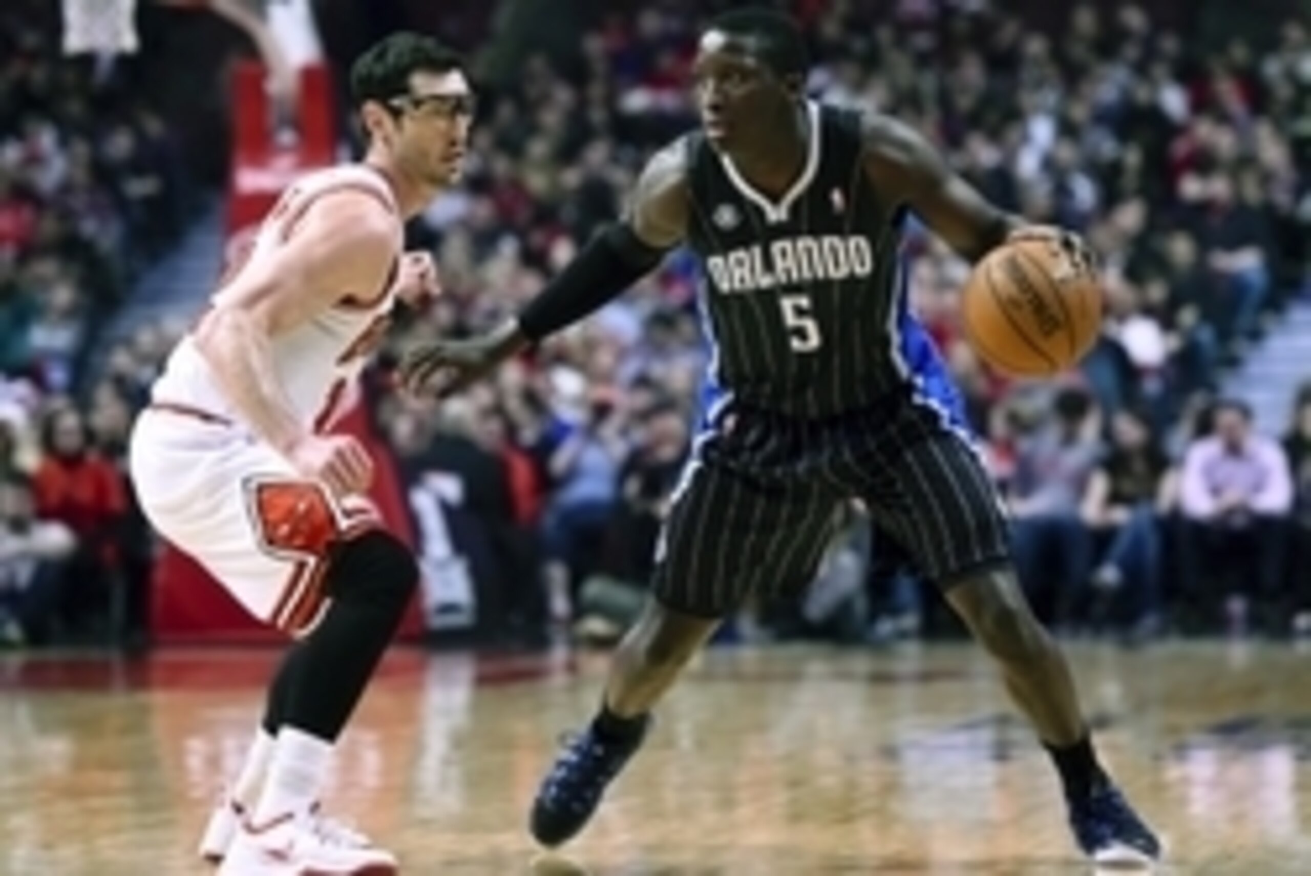 Apr 14, 2014; Chicago, IL, USA; Orlando Magic guard Victor Oladipo (5) dribbles the ball against Chicago Bulls guard Kirk Hinrich (12) during the first quarter at the United Center. Mandatory Credit: Mike DiNovo-USA TODAY Sports