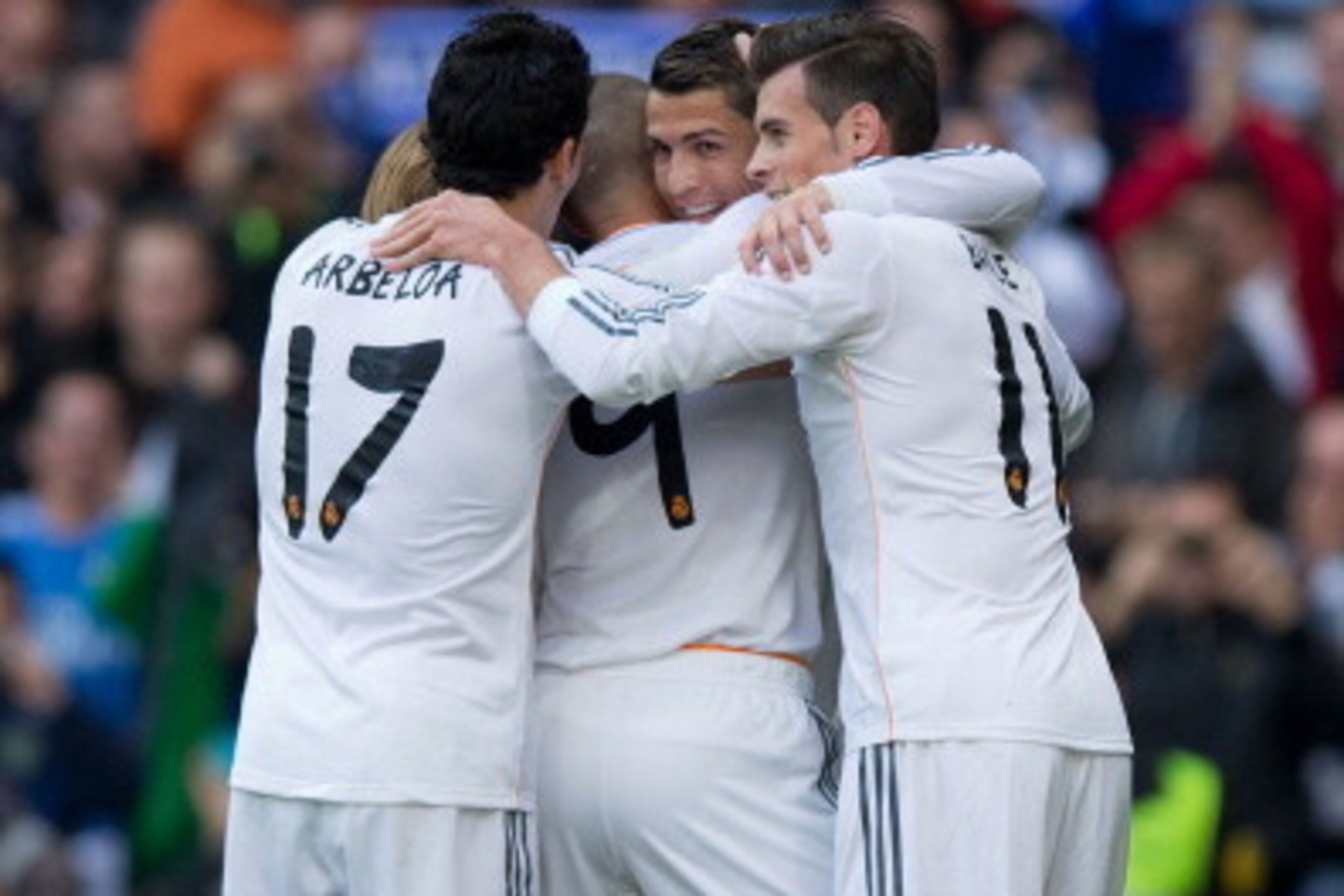 MADRID, SPAIN - NOVEMBER 09:  Karim Benzema (2ndL) celebrates scoring their second goal with teammates Cristiano Ronaldo (2ndR), Gareth Bale (R) and Alvaro Arbeloa (L) during the La Liga match between Real Madrid CF and Real Sociedad de Futbol  at Estadio