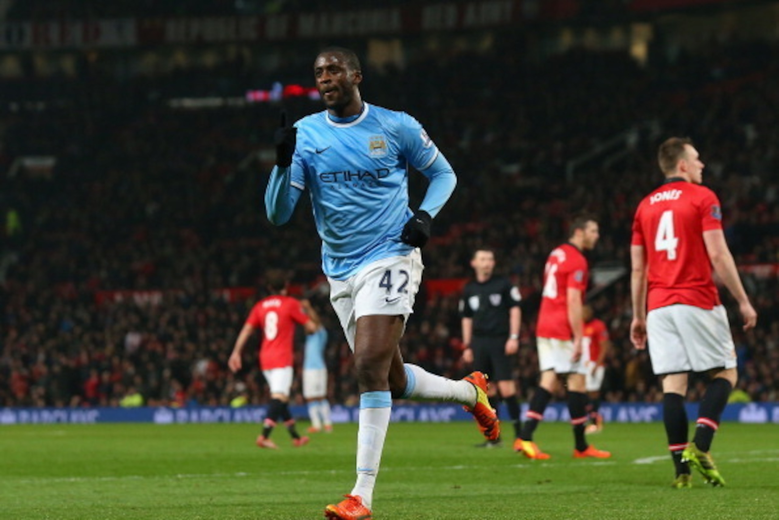 MANCHESTER, ENGLAND - MARCH 25: Yaya Toure of Manchester City celebrates scoring the third goal during the Barclays Premier League match between Manchester United and Manchester City at Old Trafford on March 25, 2014 in Manchester, England. (Photo by Al MANCHESTER, ENGLAND - MARCH 25: Yaya Toure of Manchester City celebrates scoring the third goal during the Barclays Premier League match between Manchester United and Manchester City at Old Trafford on March 25, 2014 in Manchester, England. (Photo by Al