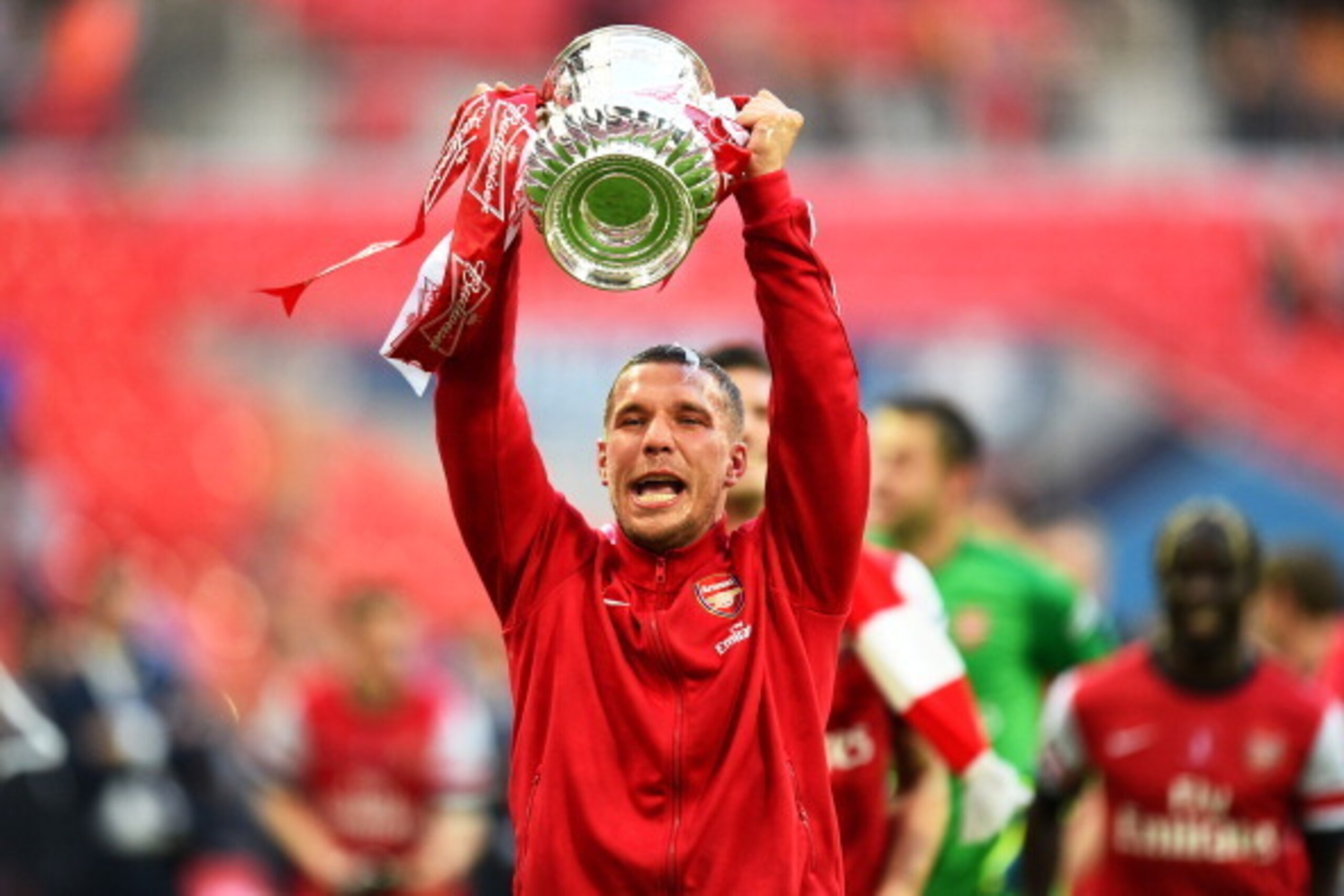 LONDON, ENGLAND - MAY 17:  Lukas Podolski of Arsenal celebrates victory with the trophy after the FA Cup with Budweiser Final match between Arsenal and Hull City at Wembley Stadium on May 17, 2014 in London, England.  (Photo by Shaun Botterill/Getty Image