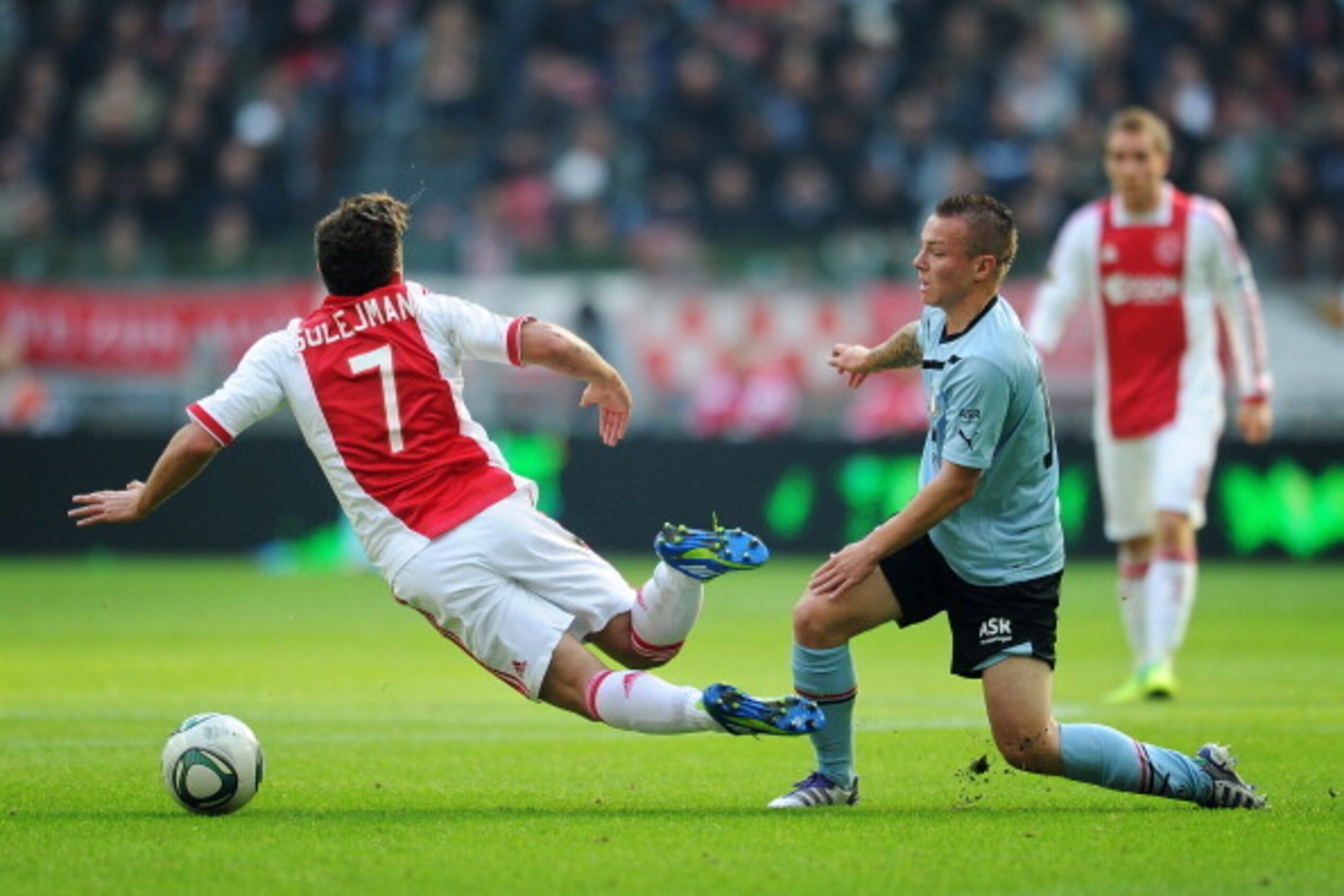 AMSTERDAM, NETHERLANDS - OCTOBER 23: Jordy Clasie of Feyenoord fouls Miralem Sulejmani of Ajax Amsterdam during the Eredivisie match between Ajax Amsterdam and Feyenoord at the Amsterdam Arena on October 23, 2011 in Amsterdam, Netherlands.  (Photo by Jasp