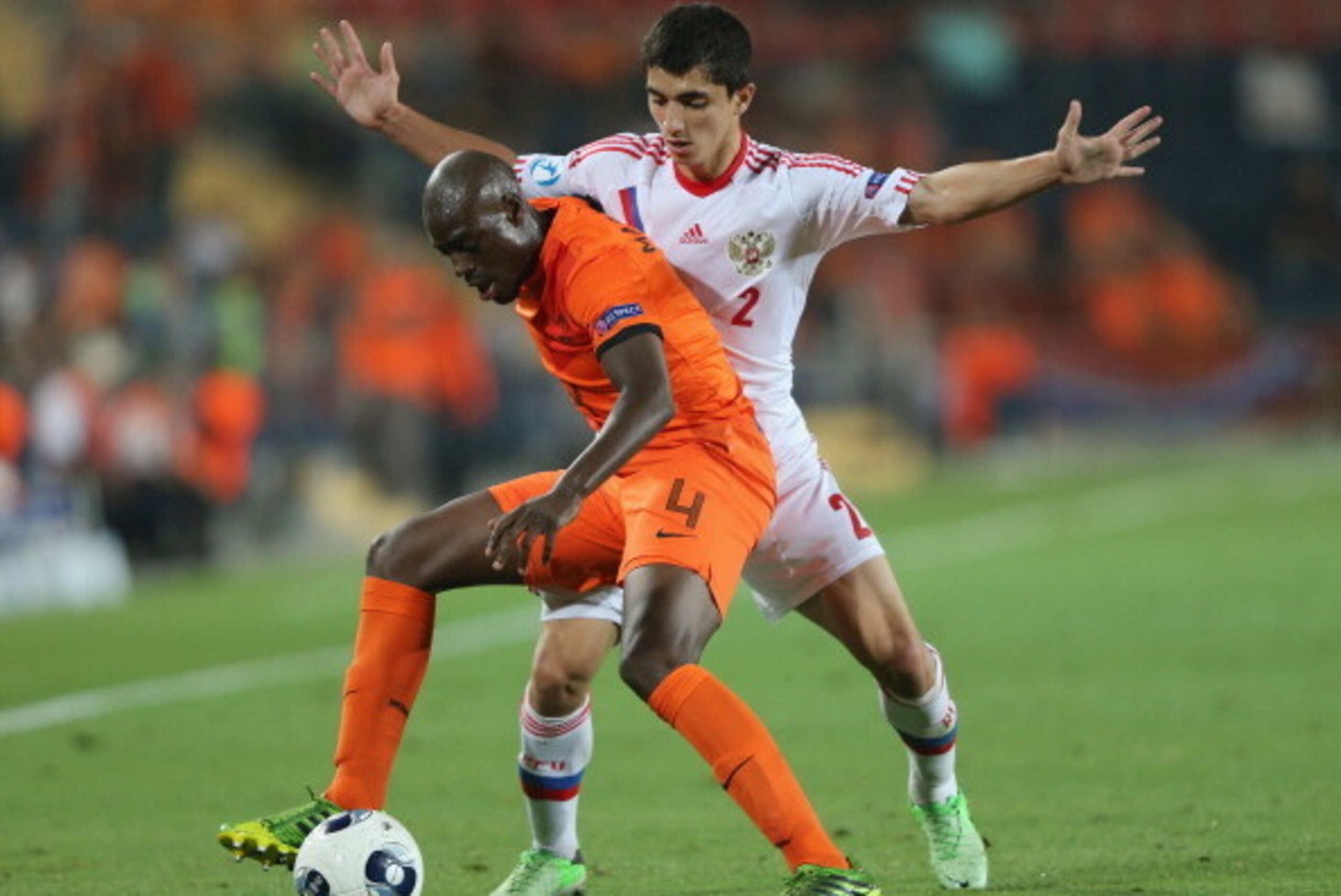 JERUSALEM, ISRAEL - JUNE 09:  Ibragim Tsallagov of Russia tries to tackle Bruno Martins Indi of The Netherlands during UEFA European U21 Championships, Group B match between The Netherlands and Russia at Teddy Stadium  on June 9, 2013 in Jerusalem, Israel