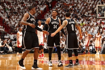 MIAMI, FL - MAY 6: Joe Johnson #7, Paul Pierce #34, and Deron Williams #8 of the Brooklyn Nets celebrate in Game One of the Eastern Conference Semi-Finals against the Miami Heat during the 2014 NBA Playoffs at American Airlines Arena on May 6, 2014 in Mia