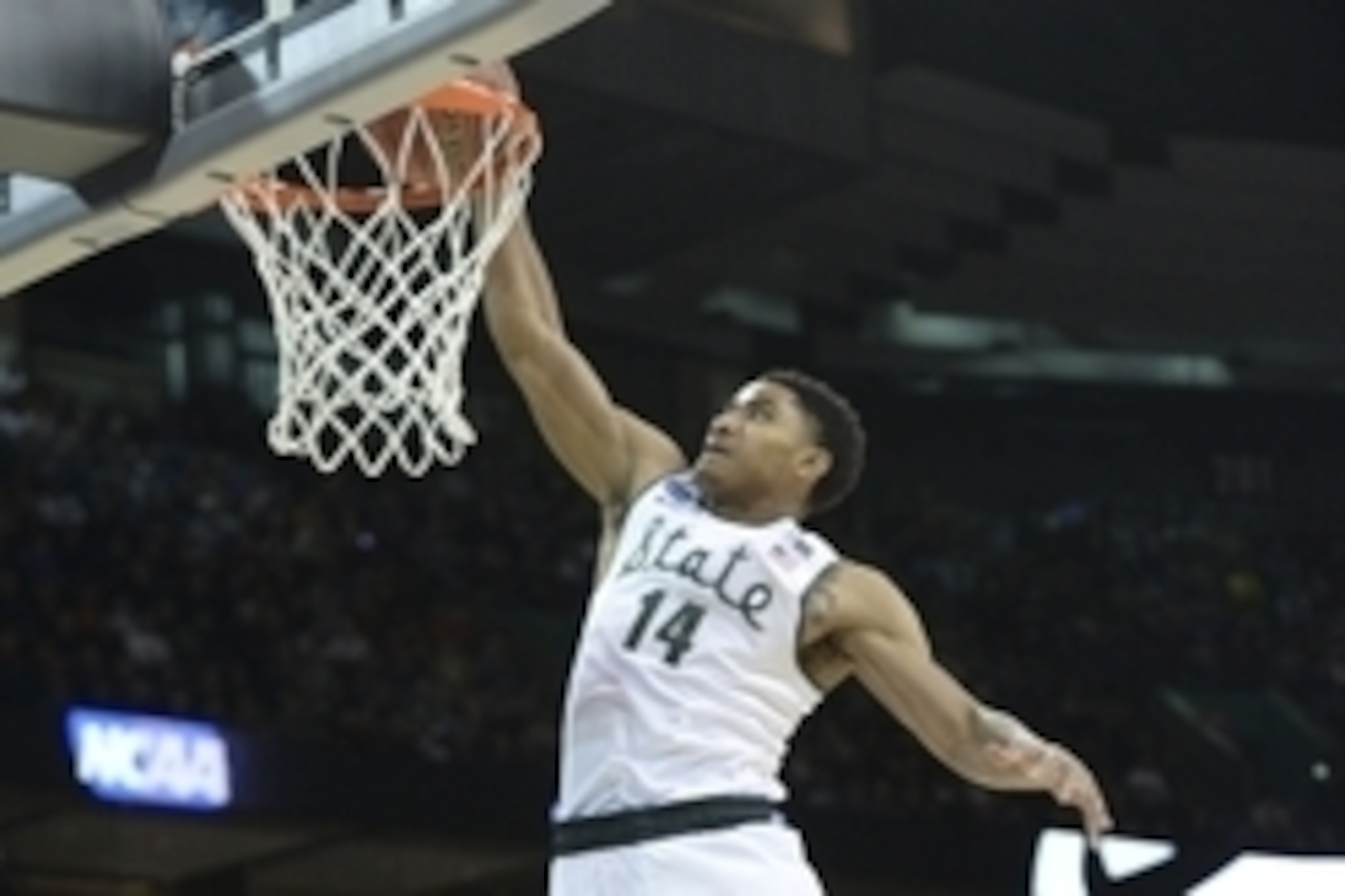 Mar 22, 2014; Spokane, WA, USA; Michigan State Spartans guard Gary Harris (14) dunks against the Harvard Crimson in the first half of a men's college basketball game during the third round of the 2014 NCAA Tournament at Veterans Memorial Arena. Mandatory 