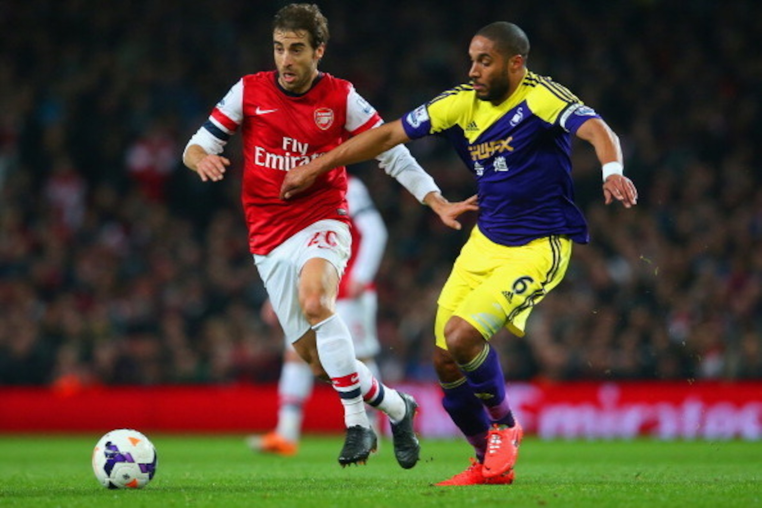 LONDON, ENGLAND - MARCH 25: Mathieu Flamini of Arsenal and Ashley Williams of Swansea City battle for the ball during the Barclays Premier League match between Arsenal and Swansea City at Emirates Stadium on March 25, 2014 in London, England. (Photo by LONDON, ENGLAND - MARCH 25: Mathieu Flamini of Arsenal and Ashley Williams of Swansea City battle for the ball during the Barclays Premier League match between Arsenal and Swansea City at Emirates Stadium on March 25, 2014 in London, England. (Photo by