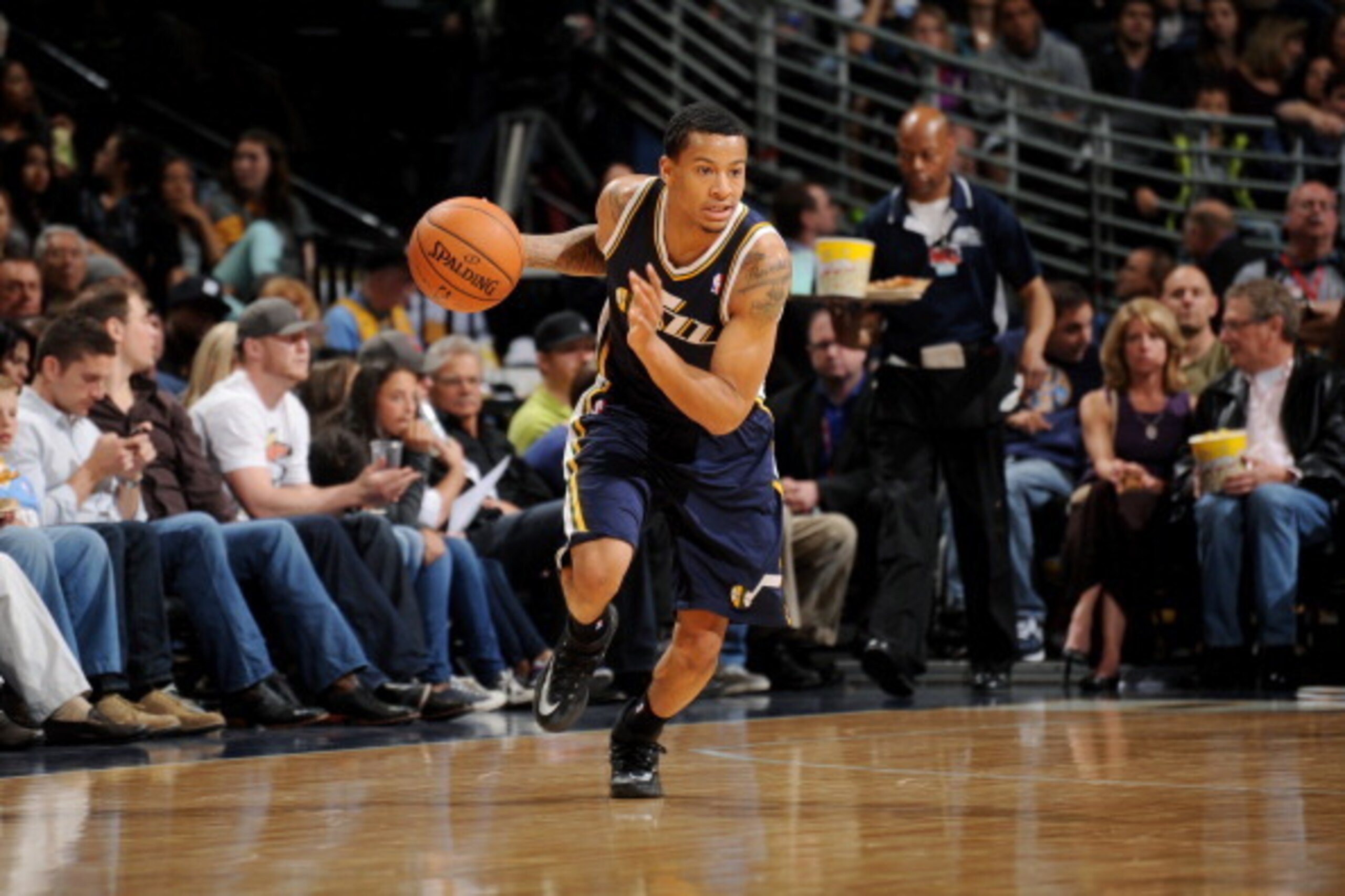 DENVER, CO - April 12: Trey Burke #3 of the Utah Jazz drives against the Denver Nuggets on April 12, 2014 at the Pepsi Center in Denver, Colorado. NOTE TO USER: User expressly acknowledges and agrees that, by downloading and/or using this Photograph, user