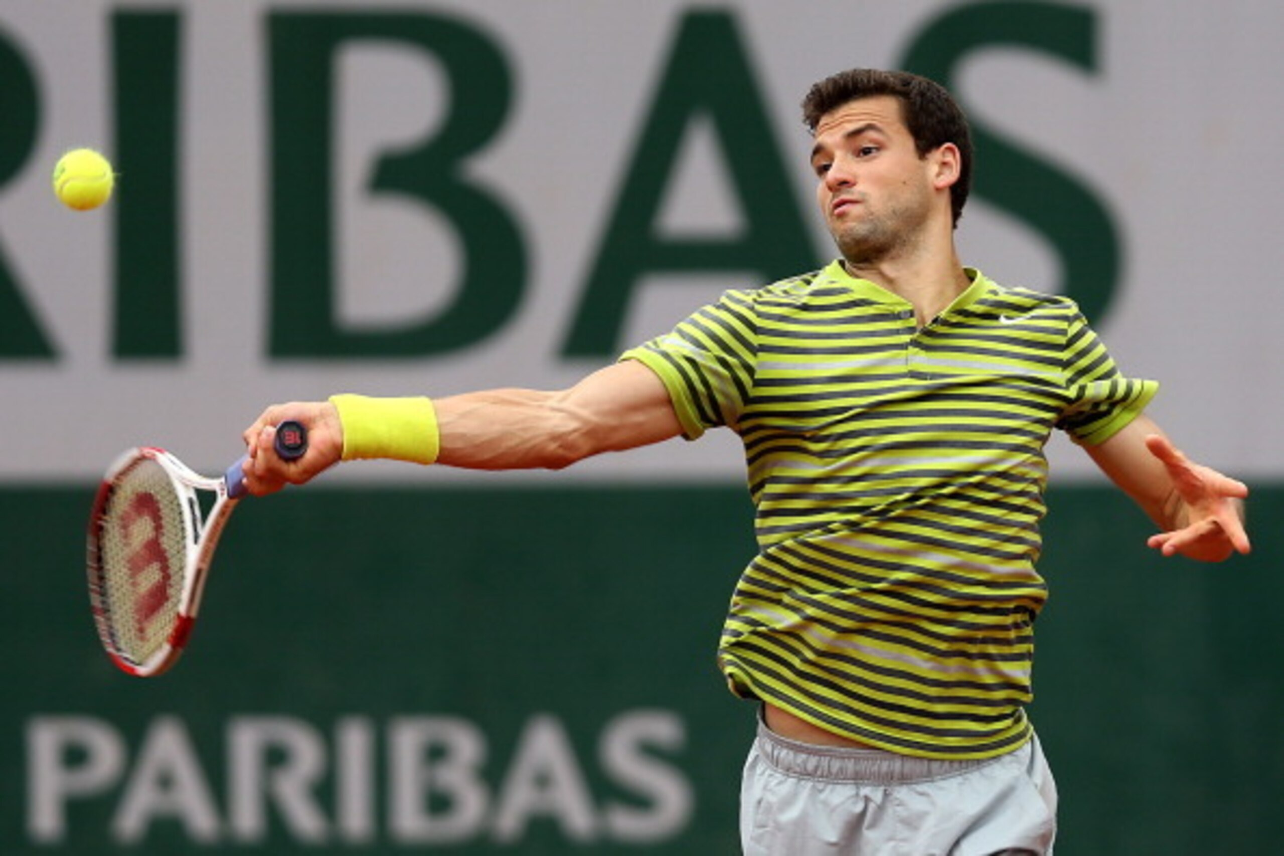 PARIS, FRANCE - MAY 27: Grigor Dimitrov of Bulgaria returns a shot during his men's singles match against Ivo Karlovic of Croatia on day three of the French Open at Roland Garros on May 27, 2014 in Paris, France. (Photo by Matthew Stockman/Getty Images) PARIS, FRANCE - MAY 27: Grigor Dimitrov of Bulgaria returns a shot during his men's singles match against Ivo Karlovic of Croatia on day three of the French Open at Roland Garros on May 27, 2014 in Paris, France. (Photo by Matthew Stockman/Getty Images)