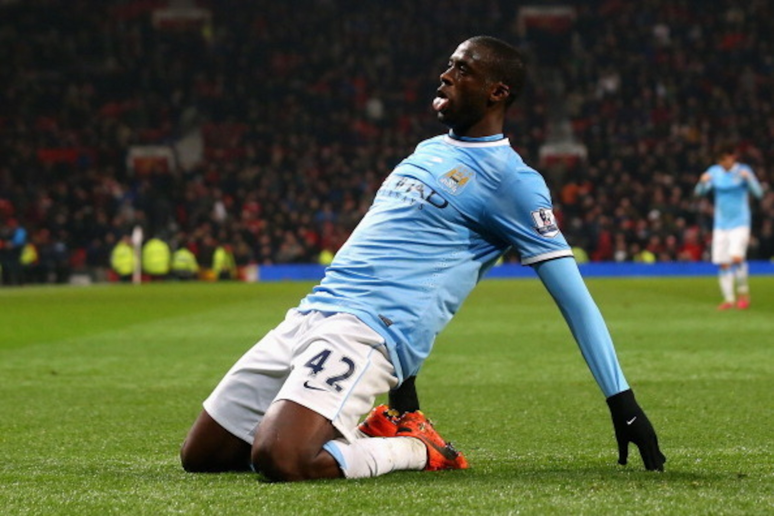 MANCHESTER, ENGLAND - MARCH 25:  Yaya Toure of Manchester City celebrates scoring the third goal during the Barclays Premier League match between Manchester United and Manchester City at Old Trafford on March 25, 2014 in Manchester, England.  (Photo by Al