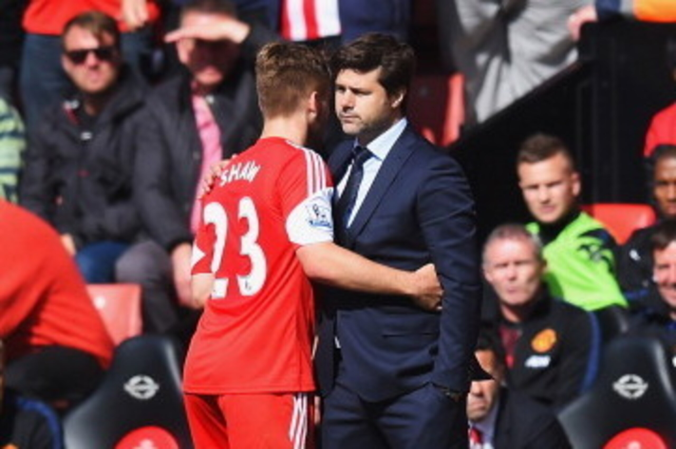 SOUTHAMPTON, ENGLAND - MAY 11:  Luke Shaw embraces his Southampton manager Mauricio Pochettino during the Barclays Premier League match between Southampton and Manchester United at St Mary's Stadium on May 11, 2014 in Southampton, England.  (Photo by Mike