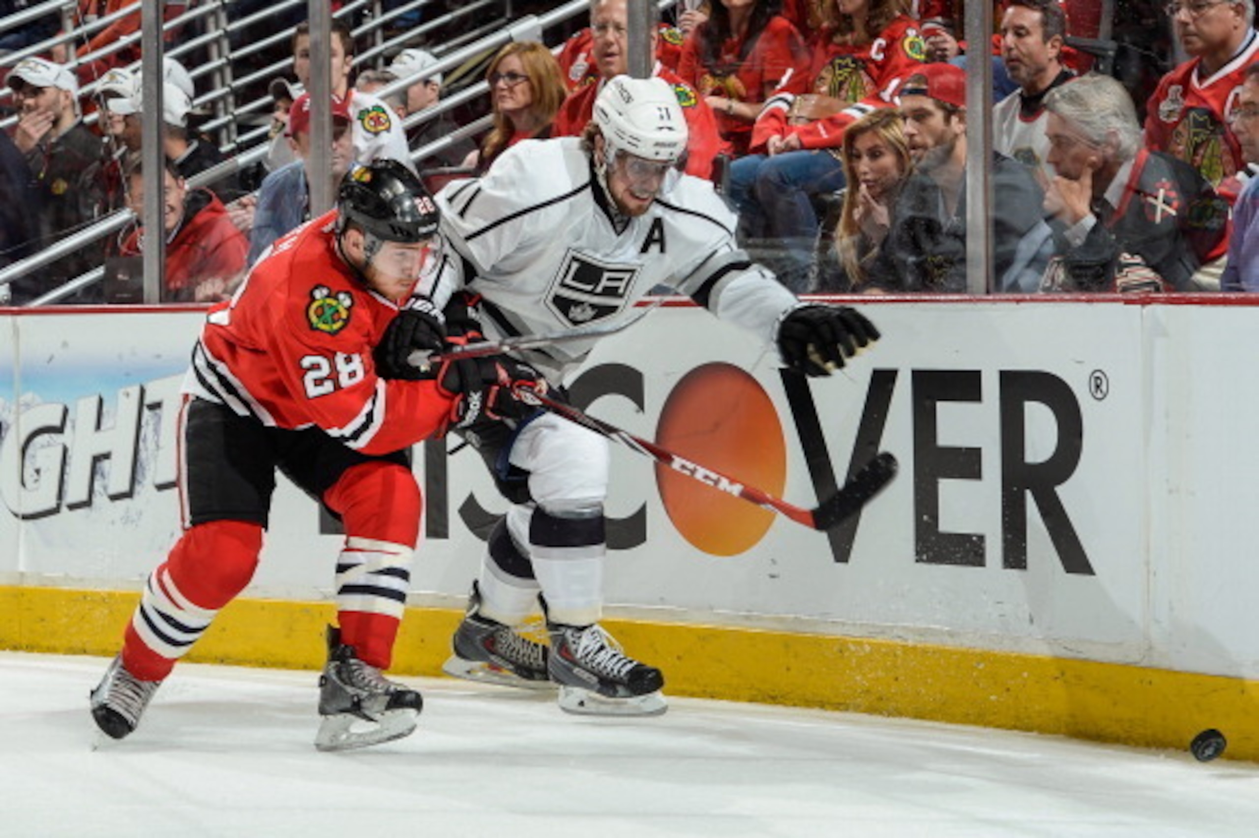 CHICAGO, IL - MAY 21: Ben Smith #28 of the Chicago Blackhawks and Anze Kopitar #11 of the Los Angeles Kings chase the puck in Game Two of the Western Conference Final during the 2014 NHL Stanley Cup Playoffs at the United Center on May 21, 2014 in Chicago